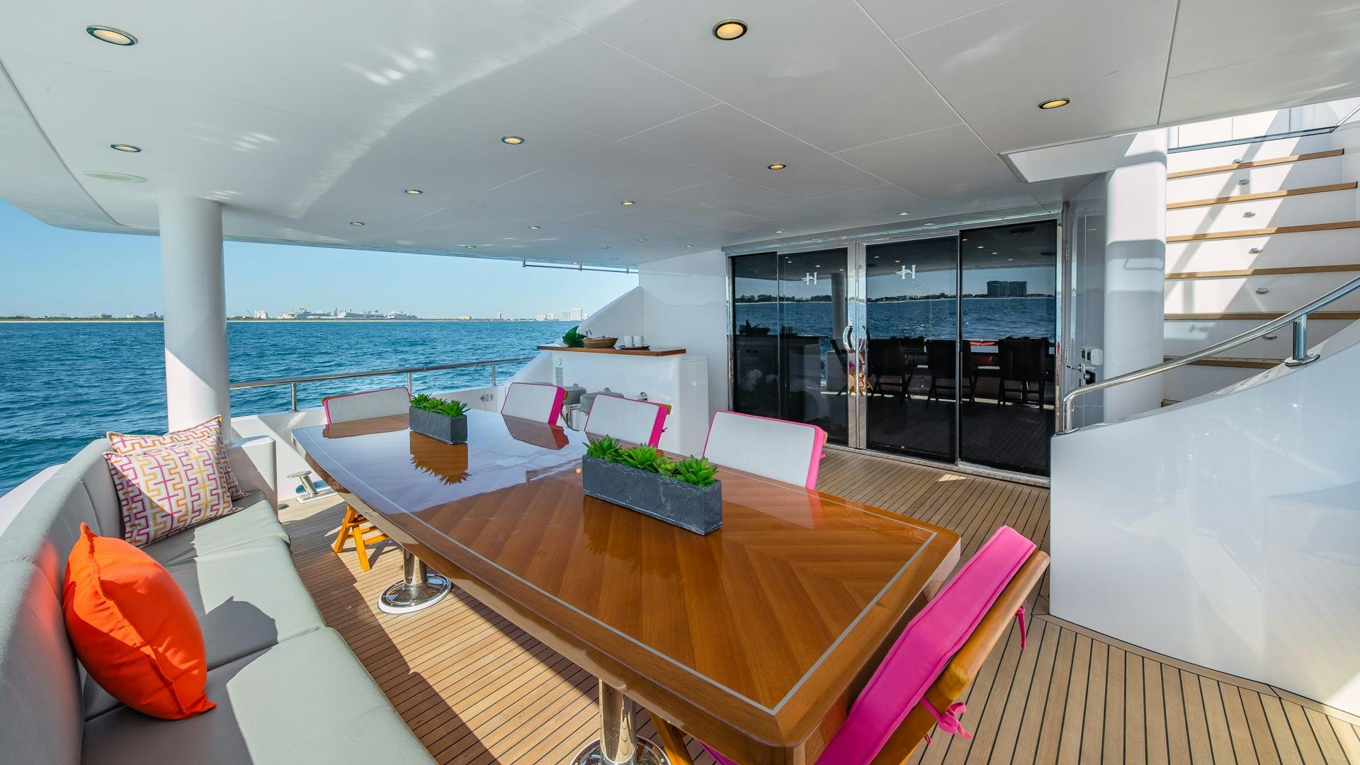 a room with a table and chairs aboard RISK TAKER Yacht for Sale