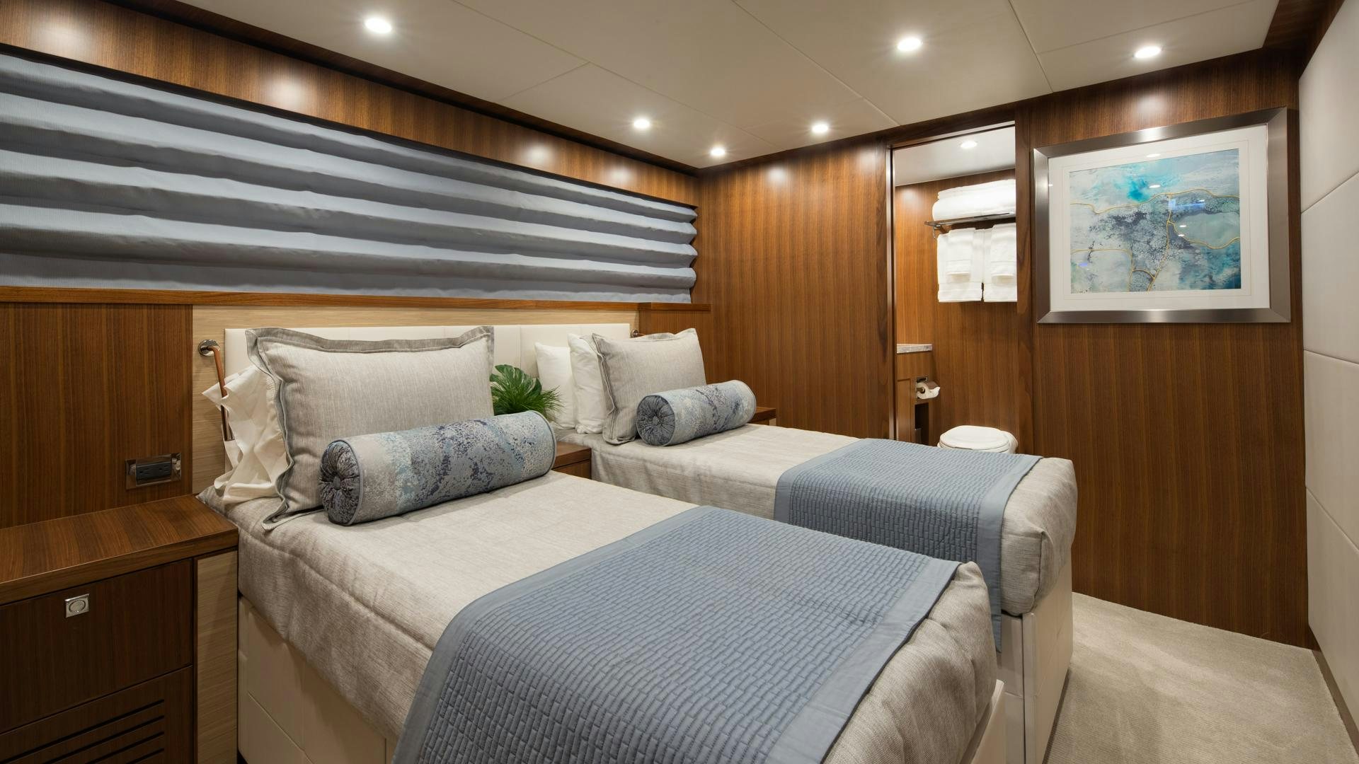 a room with a bed and a desk aboard RISK TAKER Yacht for Charter