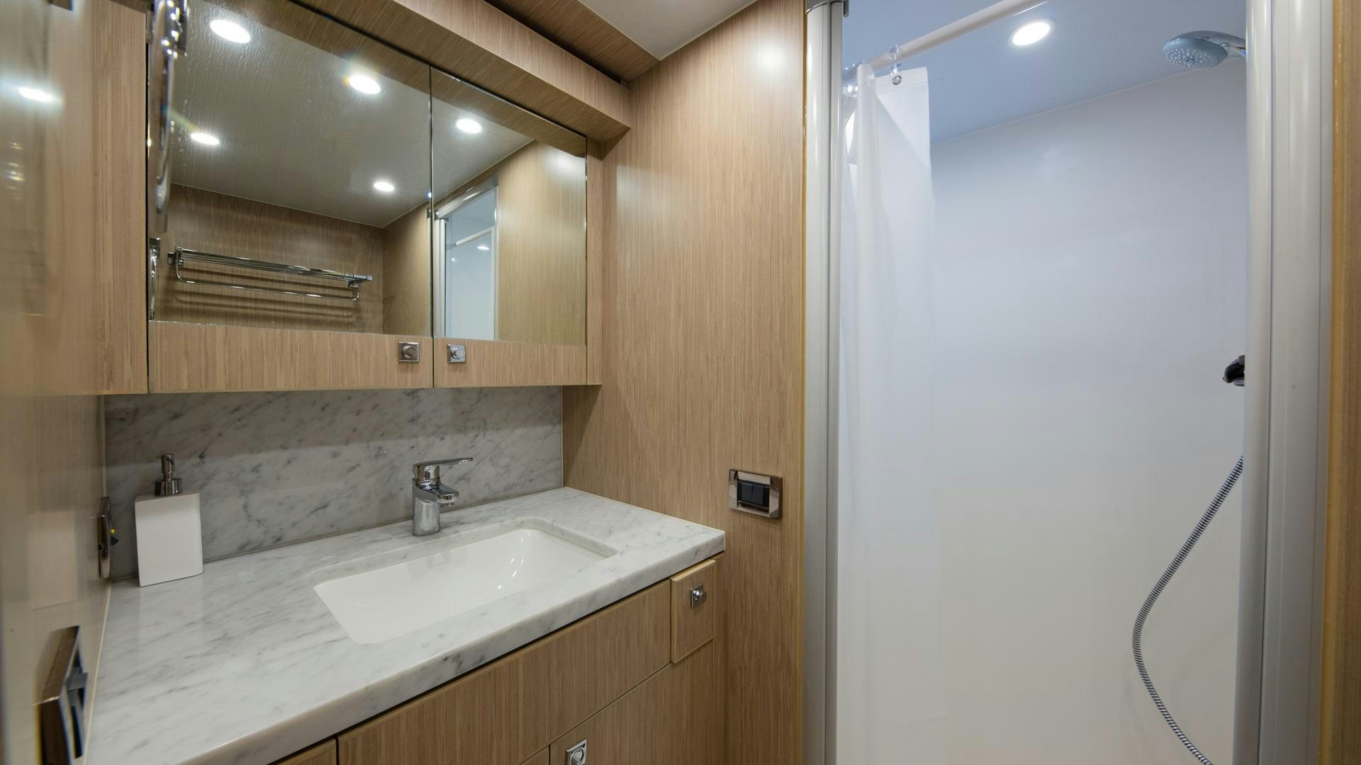 a bathroom with a sink and a mirror aboard RISK TAKER Yacht for Charter