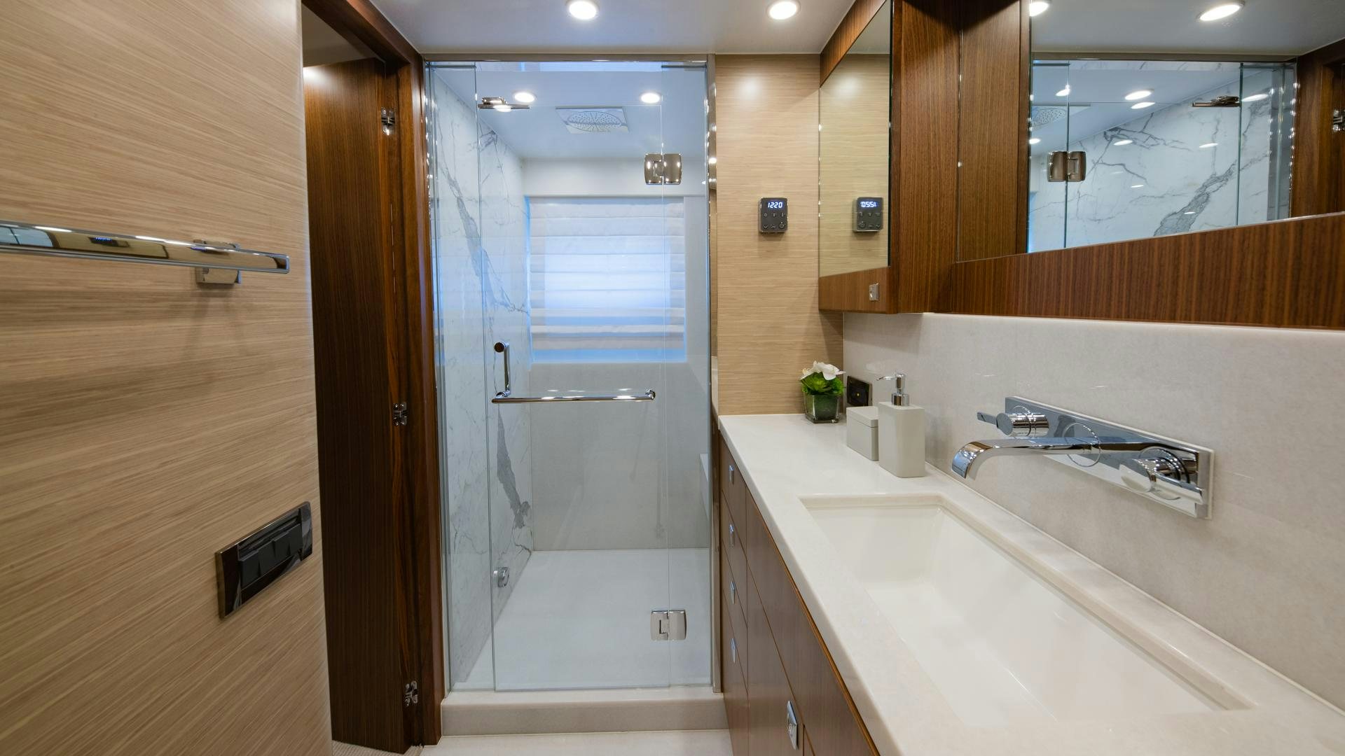 a bathroom with a glass shower aboard RISK TAKER Yacht for Sale
