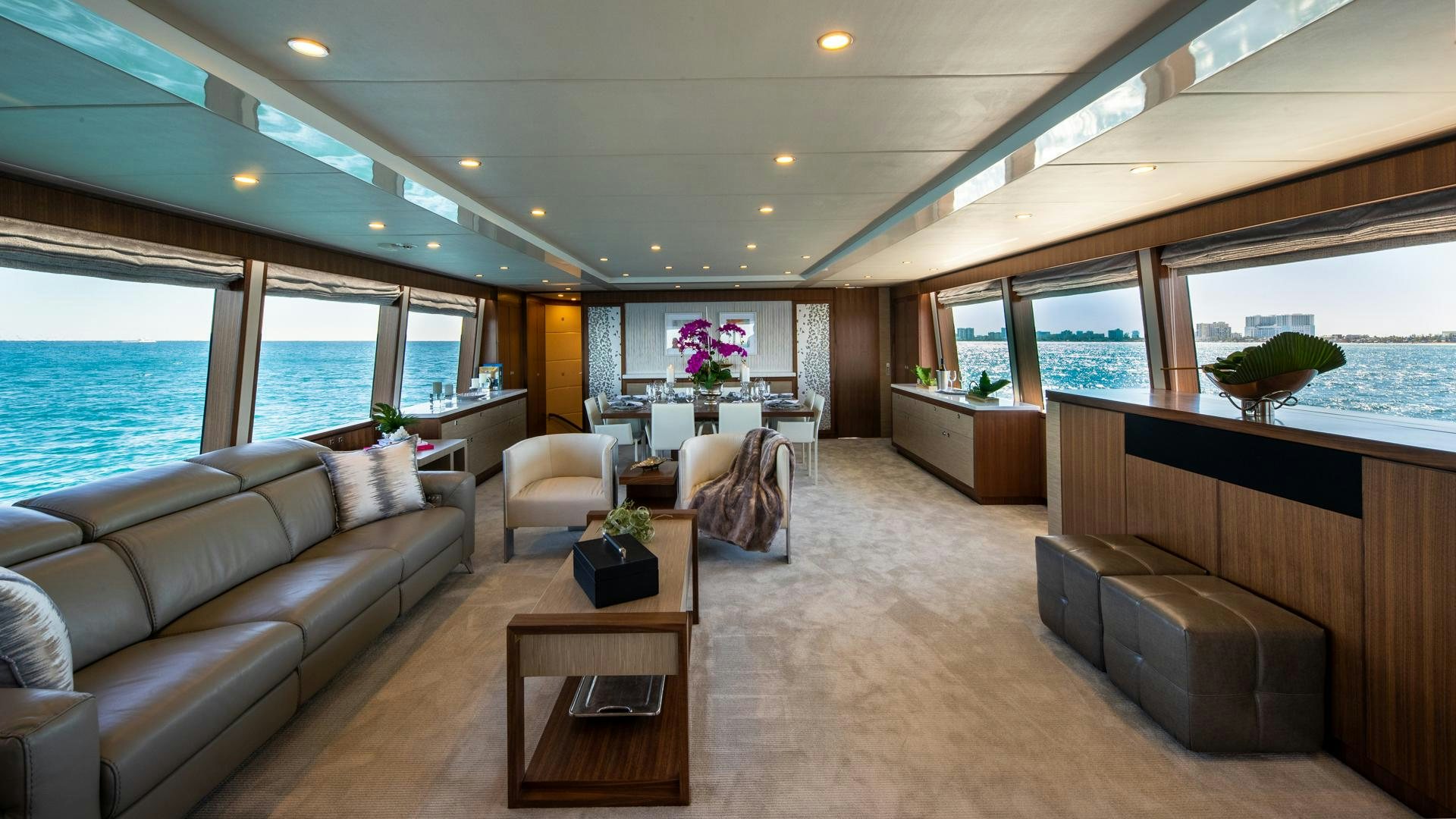 a living room with a couch and a table aboard RISK TAKER Yacht for Charter