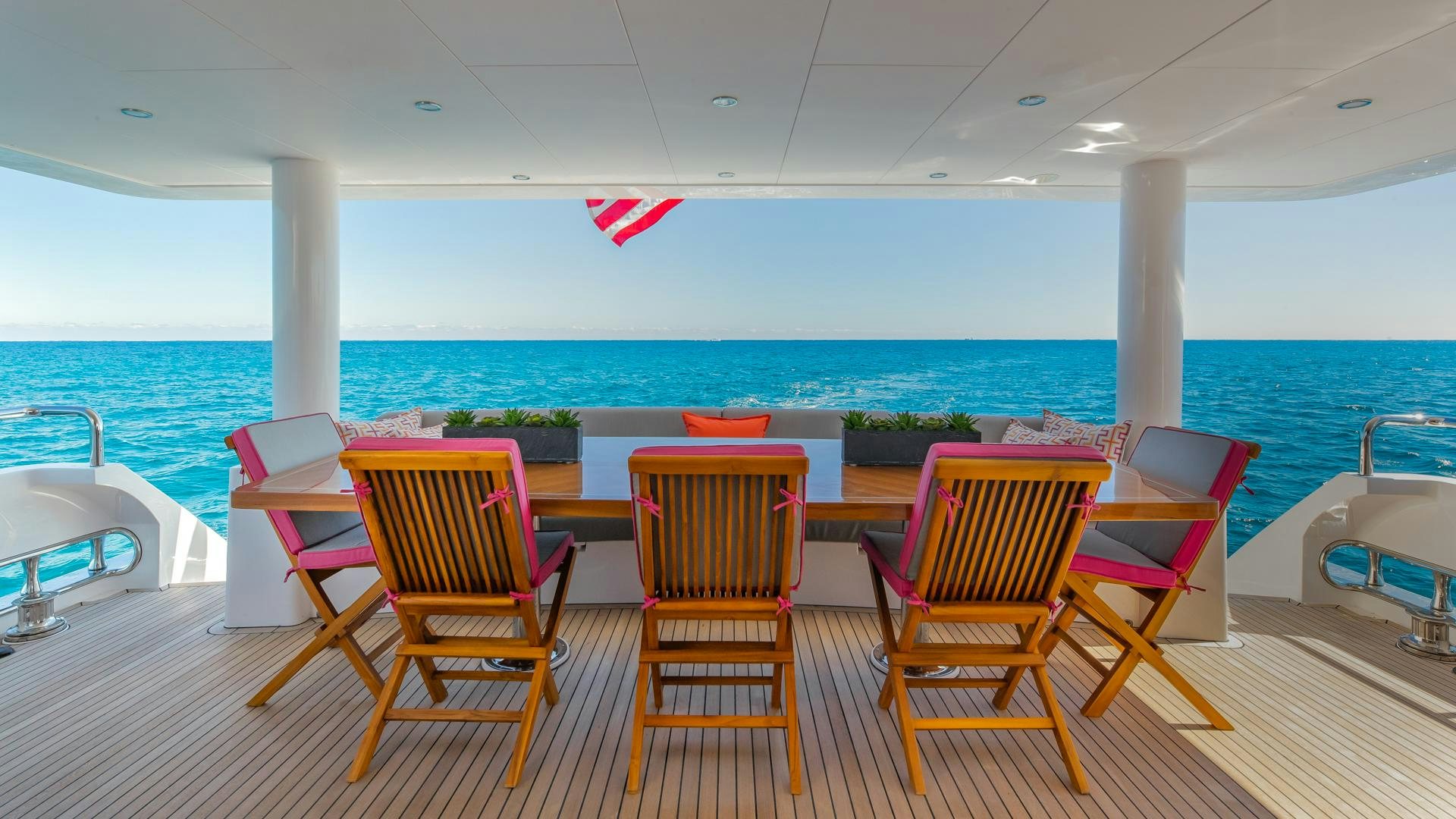 a group of chairs on a deck overlooking a body of water aboard RISK TAKER Yacht for Sale