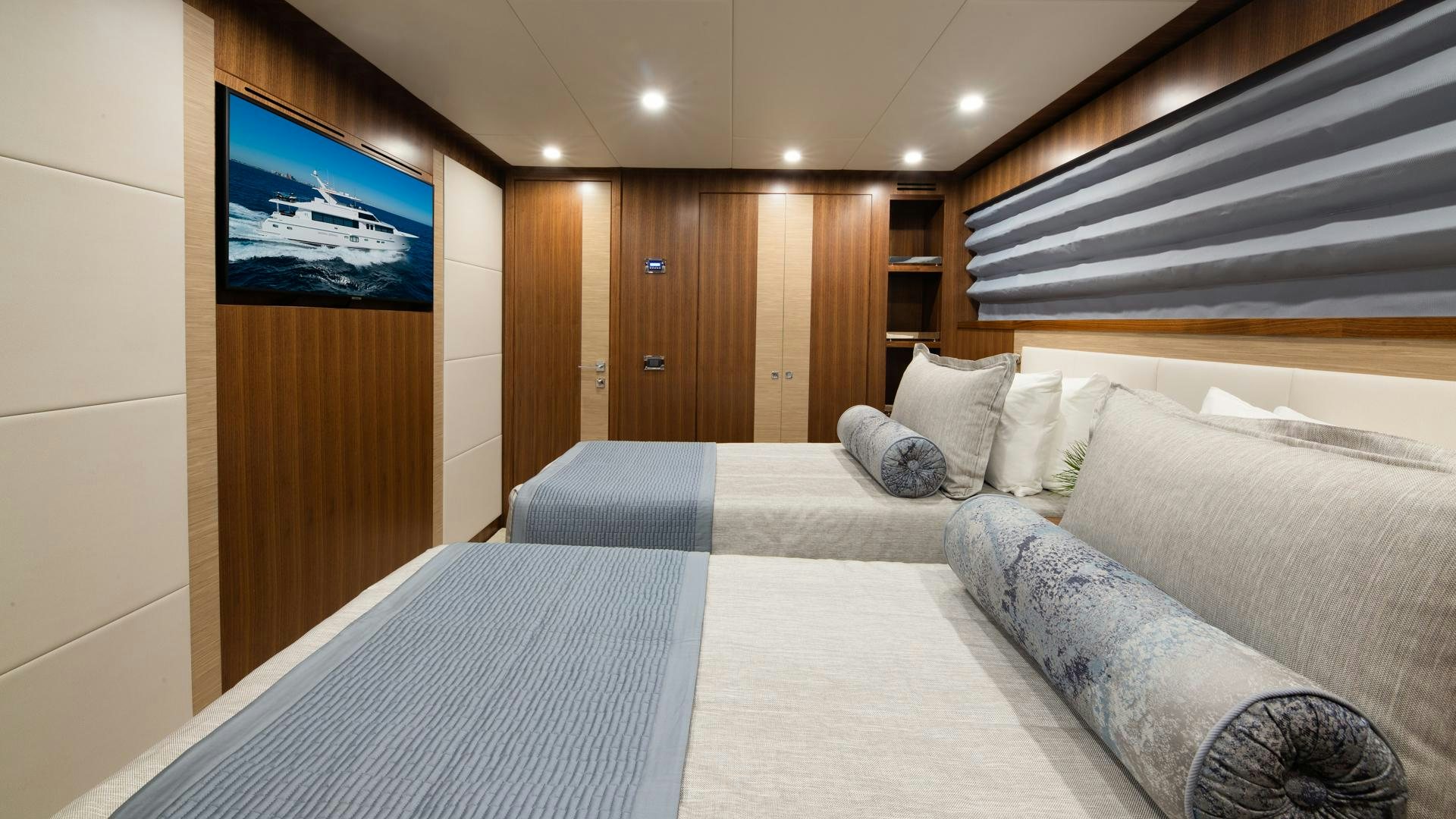 a bed and a television in a room aboard RISK TAKER Yacht for Sale