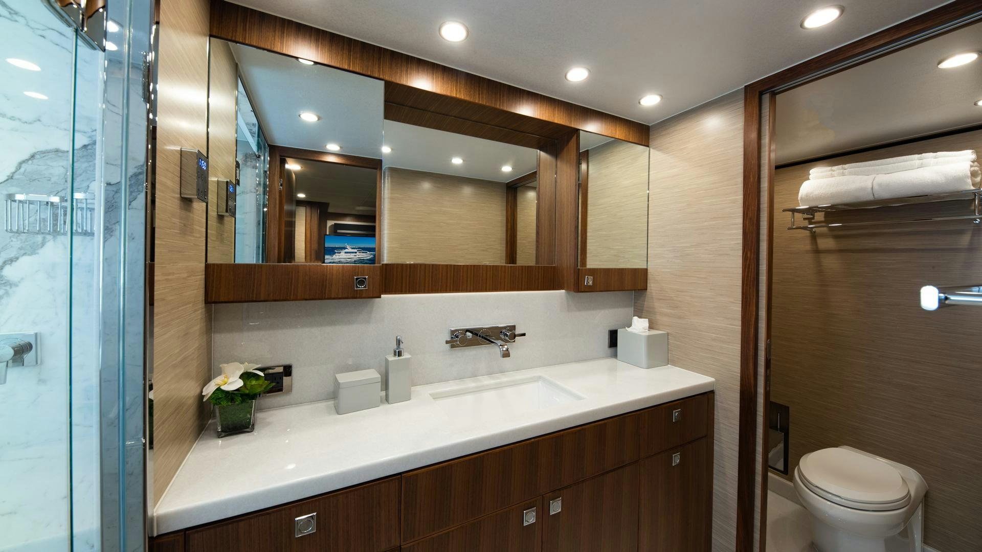 a bathroom with a large mirror aboard RISK TAKER Yacht for Sale