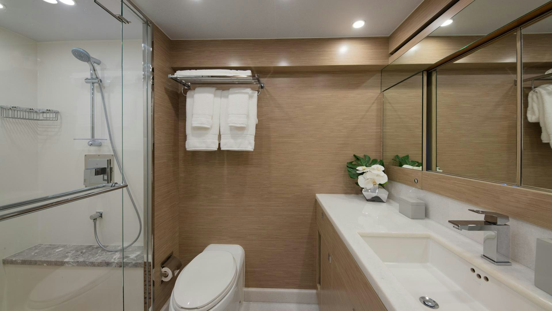 a bathroom with a glass shower aboard RISK TAKER Yacht for Sale