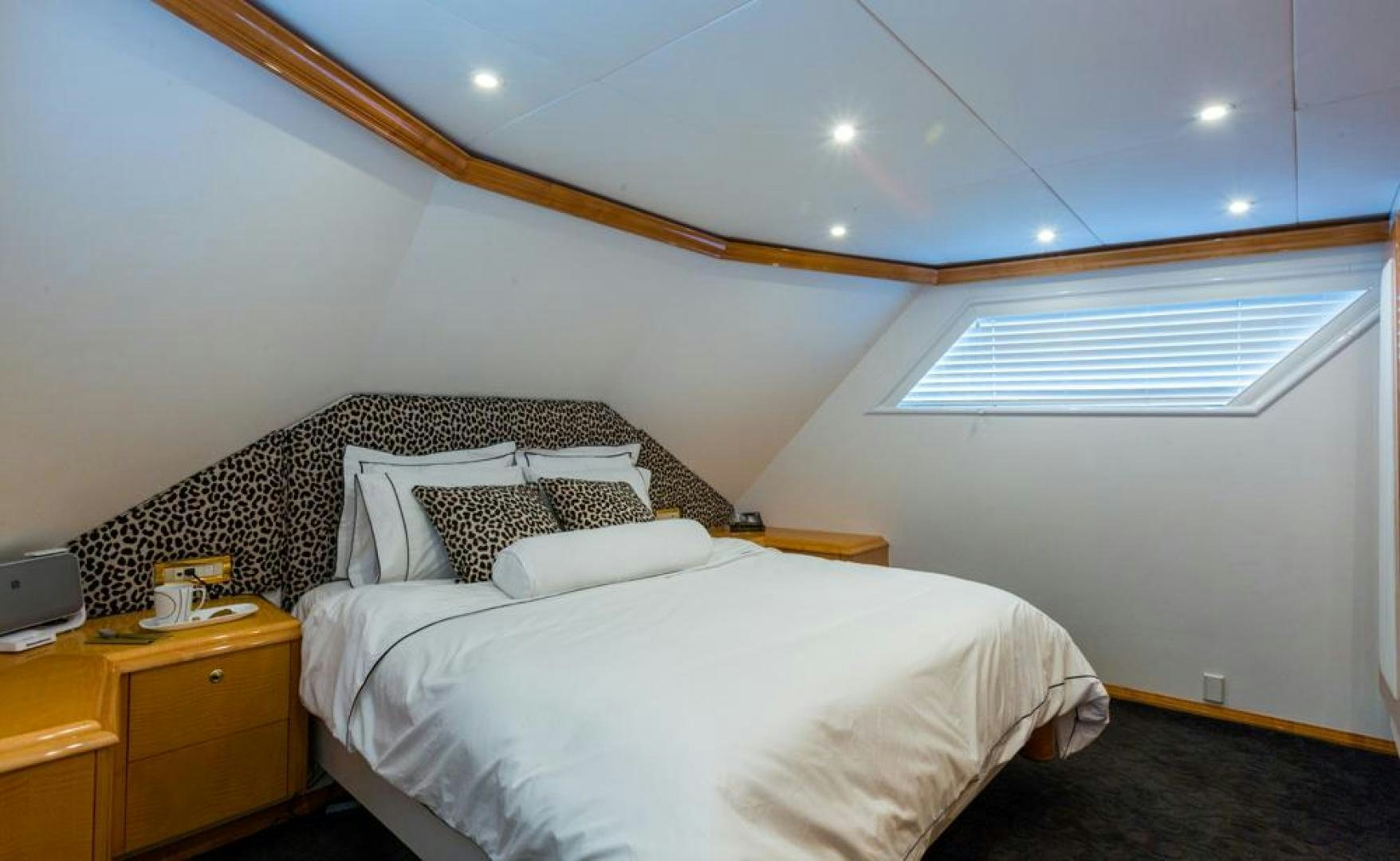 a bedroom with a bed and a desk aboard PIRATE RADIO Yacht for Sale