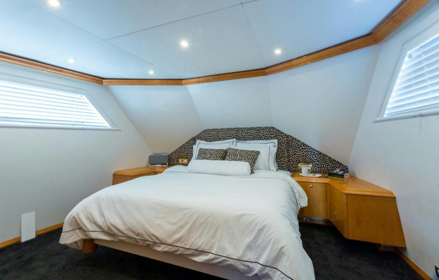 a bed with a white comforter aboard PIRATE RADIO Yacht for Sale