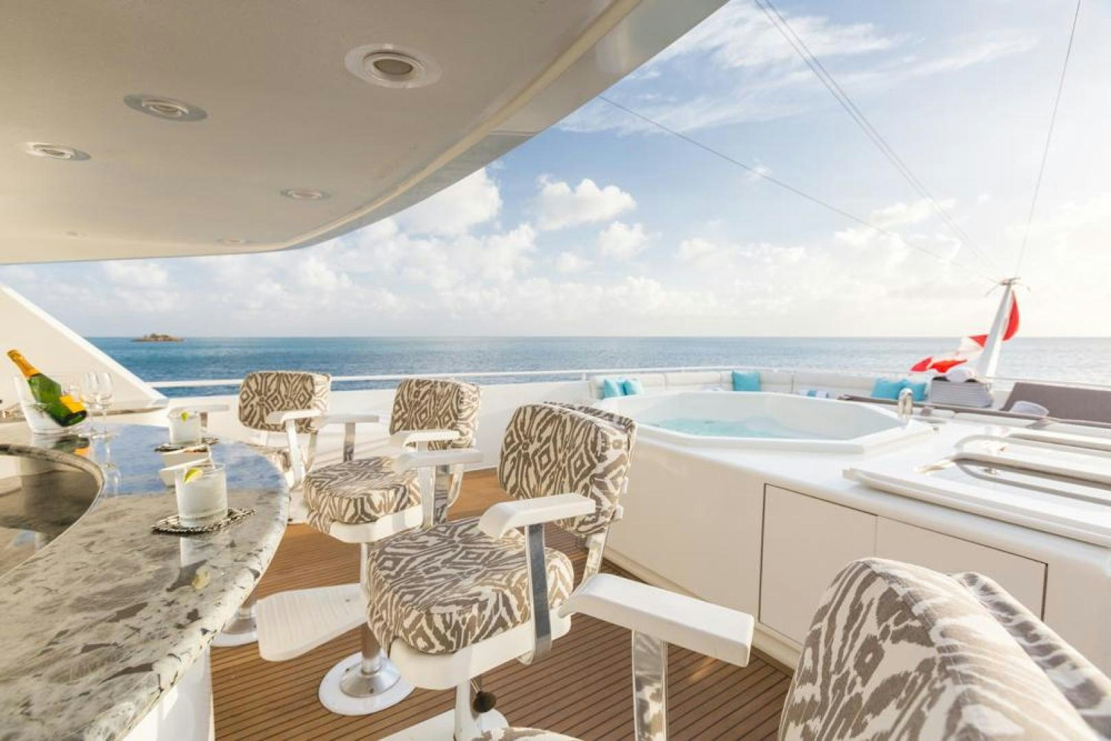 a room with a table chairs and a view of the ocean aboard PIRATE RADIO Yacht for Sale