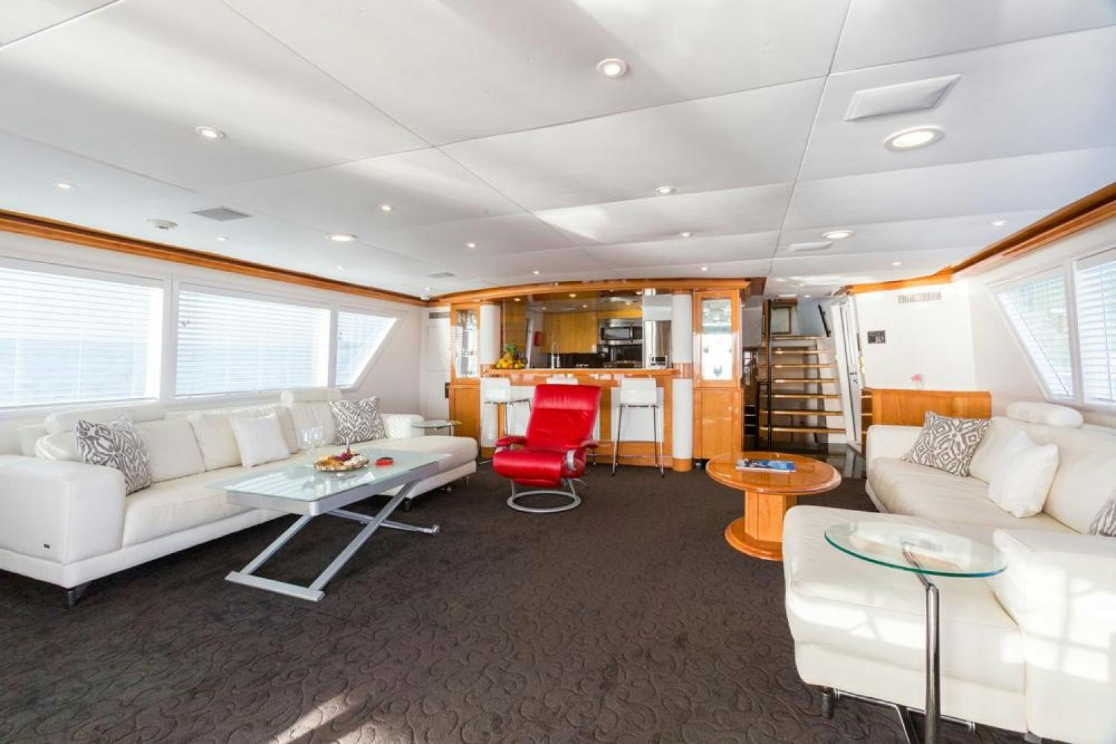 a living room with a red chair aboard PIRATE RADIO Yacht for Sale