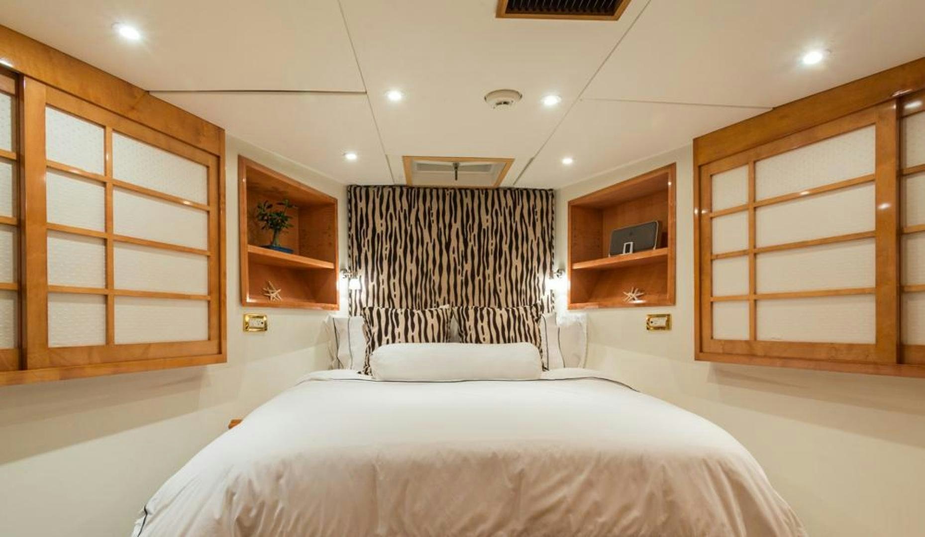 a room with a bed and a shelf aboard PIRATE RADIO Yacht for Sale