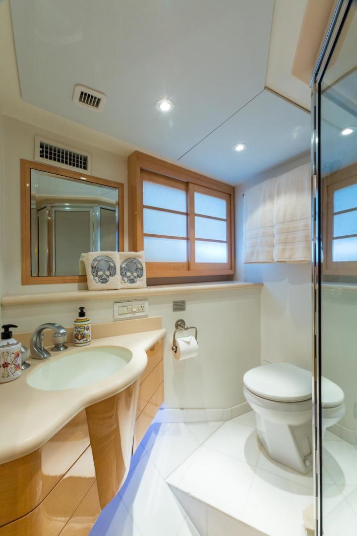 a bathroom with a sink toilet and a mirror aboard PIRATE RADIO Yacht for Sale