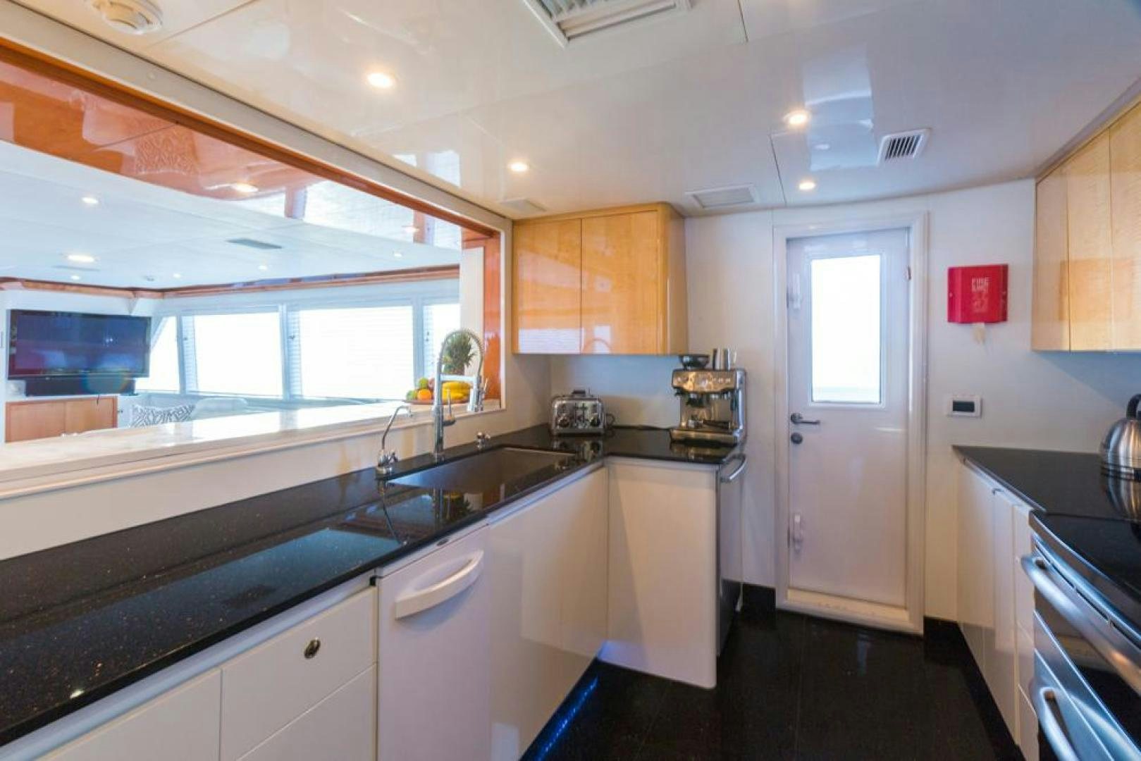 a kitchen with white cabinets aboard PIRATE RADIO Yacht for Sale