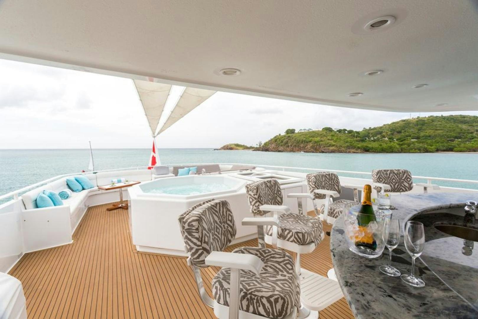 a table and chairs on a deck aboard PIRATE RADIO Yacht for Sale