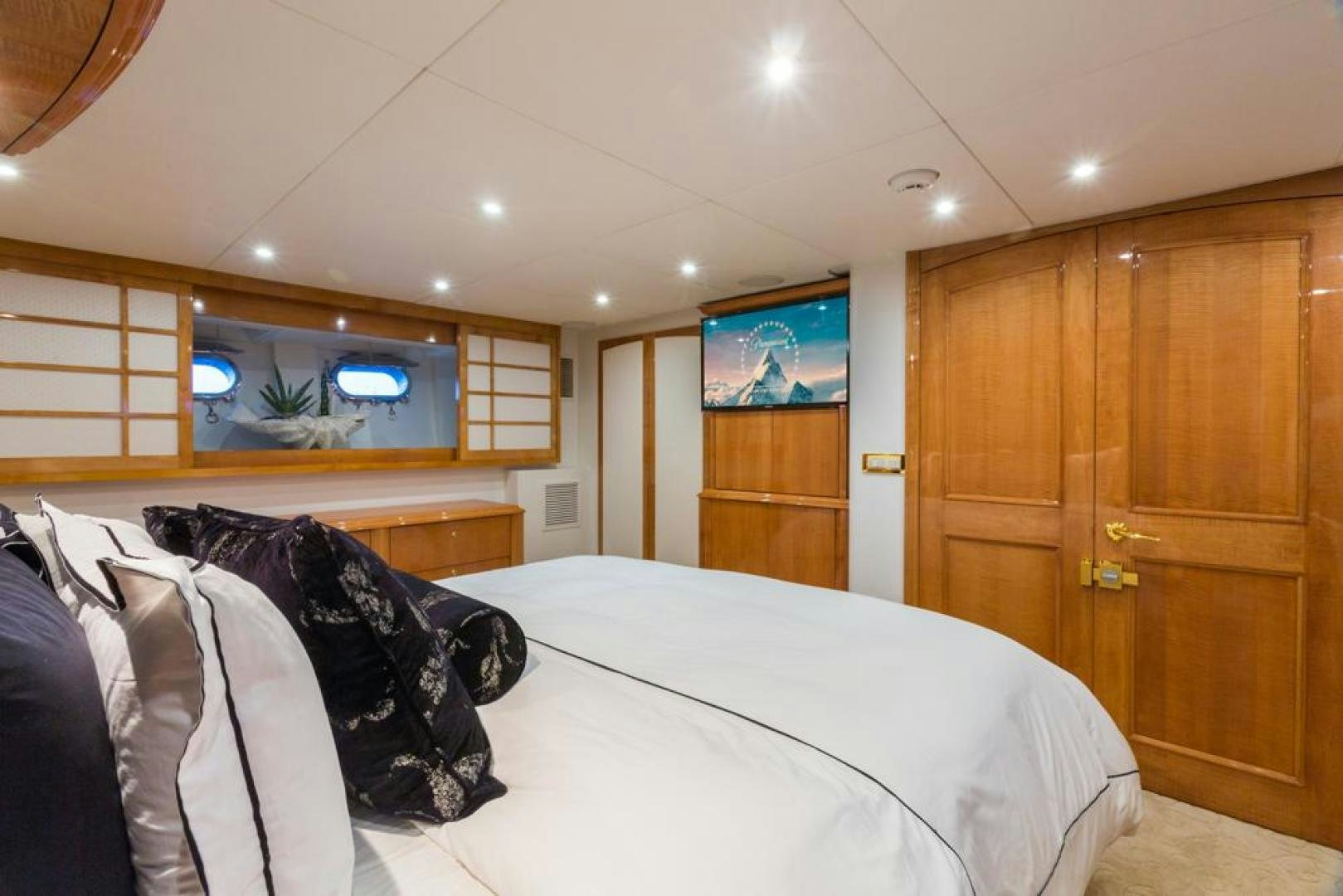 a bedroom with a bed and a television aboard PIRATE RADIO Yacht for Sale