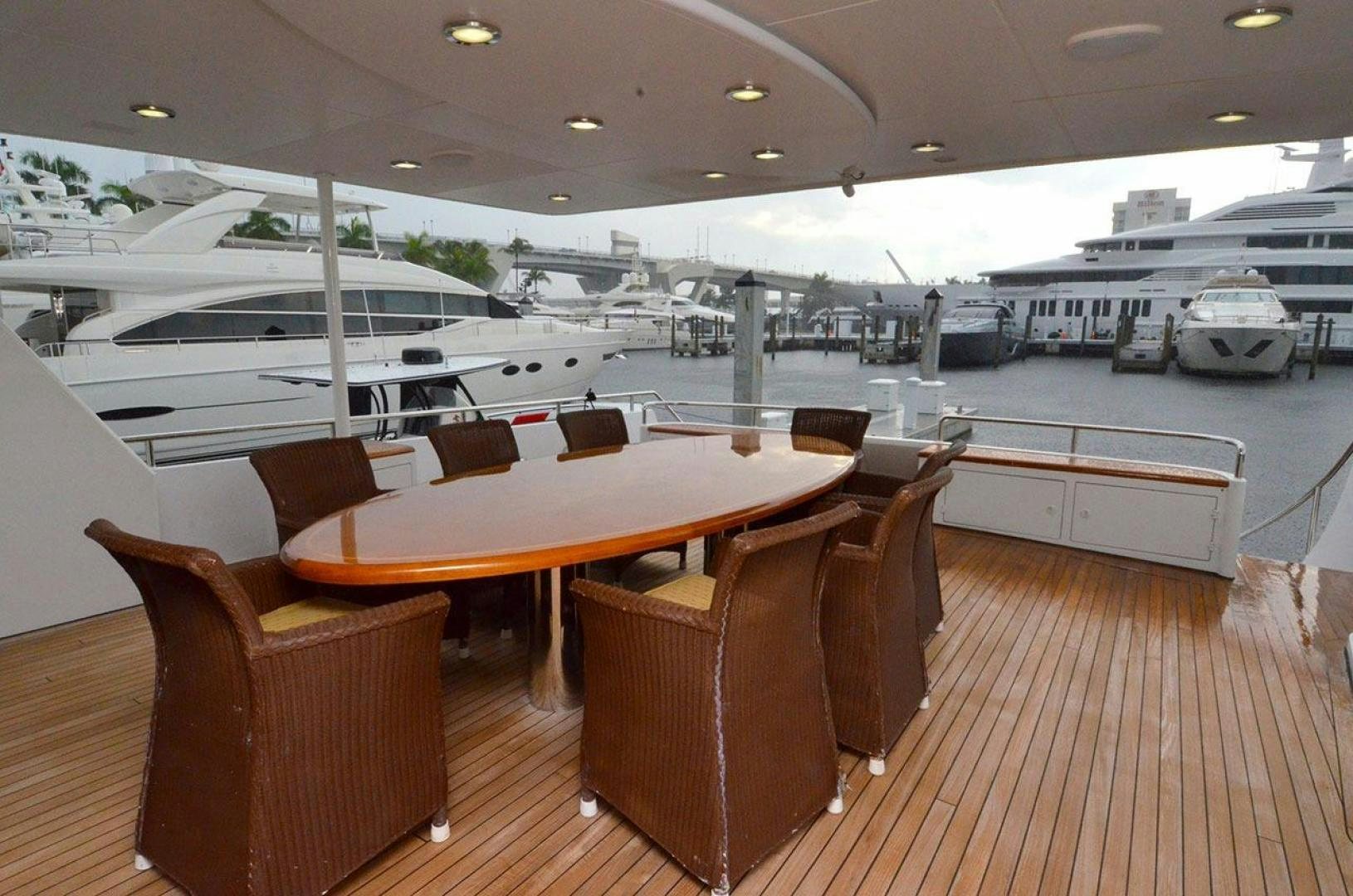 a room with a table chairs and a large group of boats in it aboard LADY ARLENE Yacht for Sale