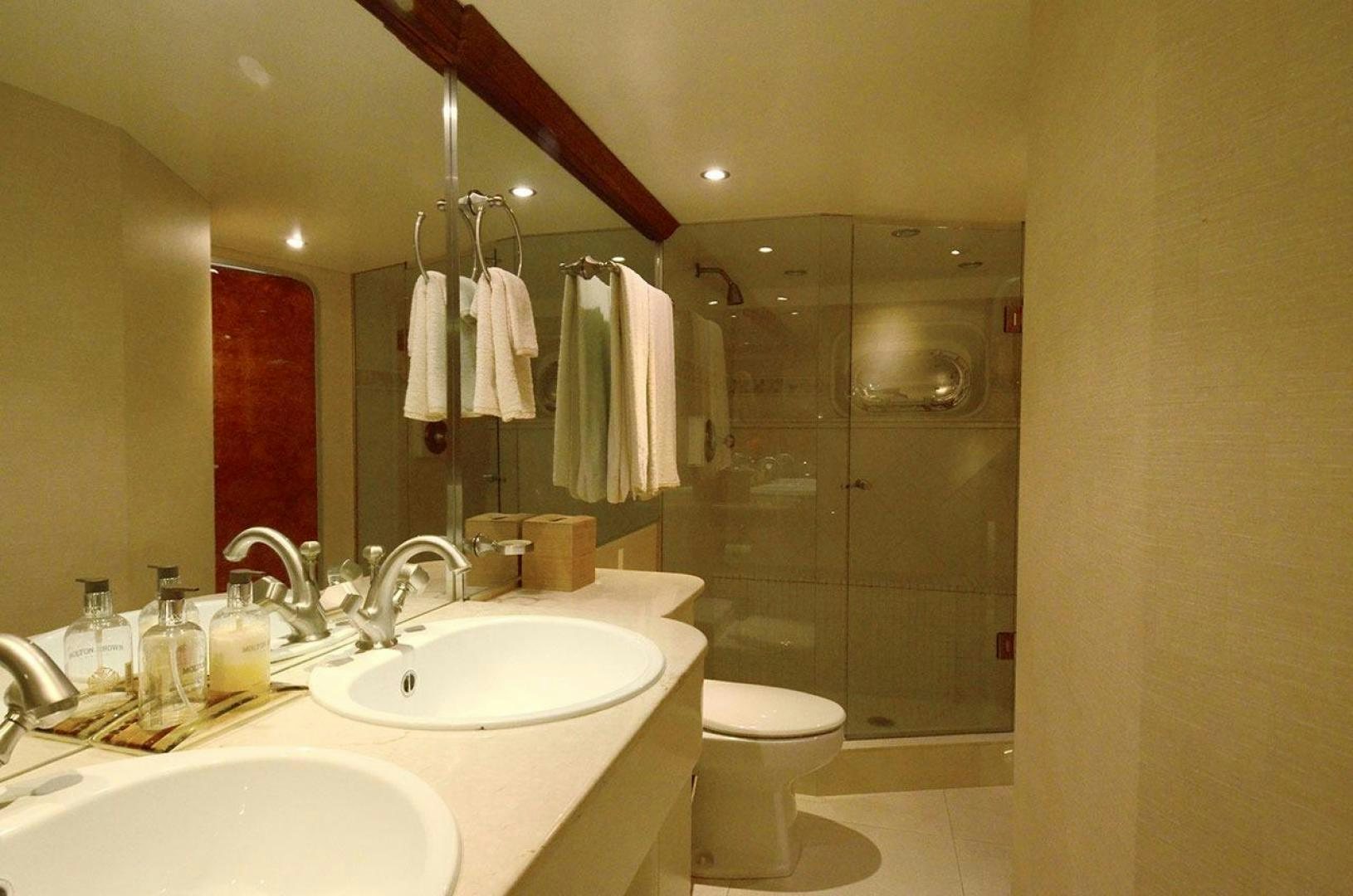 a bathroom with a large mirror aboard LADY ARLENE Yacht for Sale