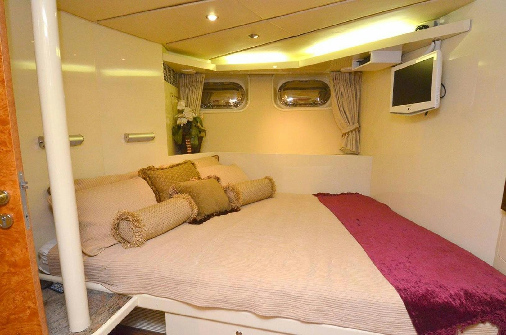a bed with a pink comforter aboard LADY ARLENE Yacht for Sale