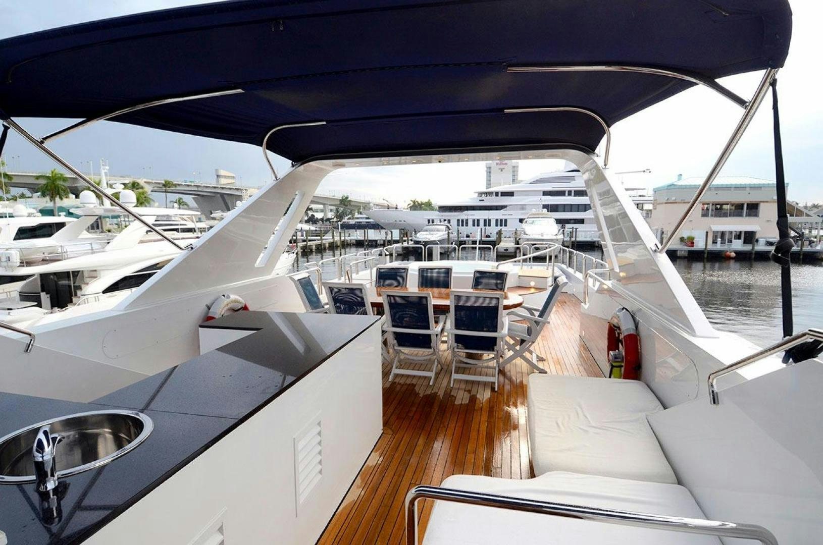 a boat with a deck and chairs aboard LADY ARLENE Yacht for Sale
