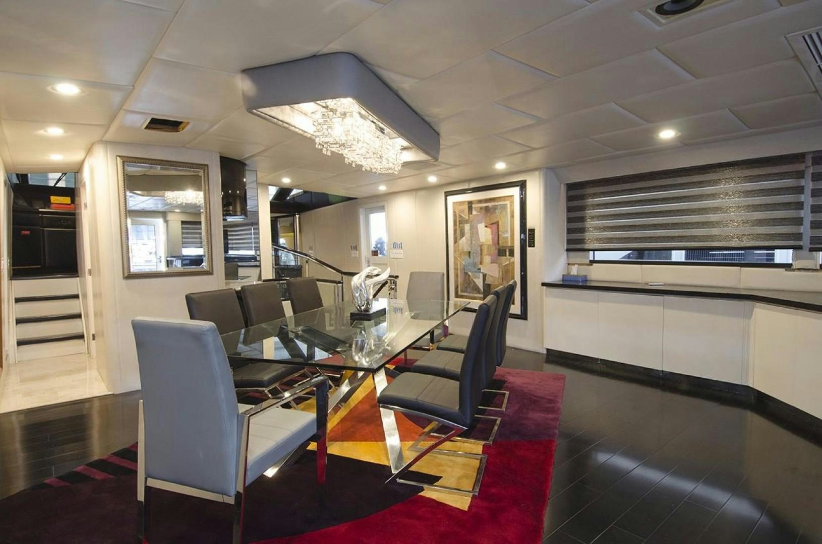 a room with a table and chairs aboard GOLDEN TOUCH Yacht for Sale