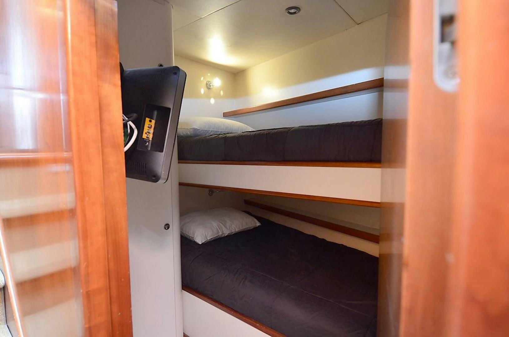 a room with a bed and a desk aboard OUTTA TOUCH Yacht for Sale