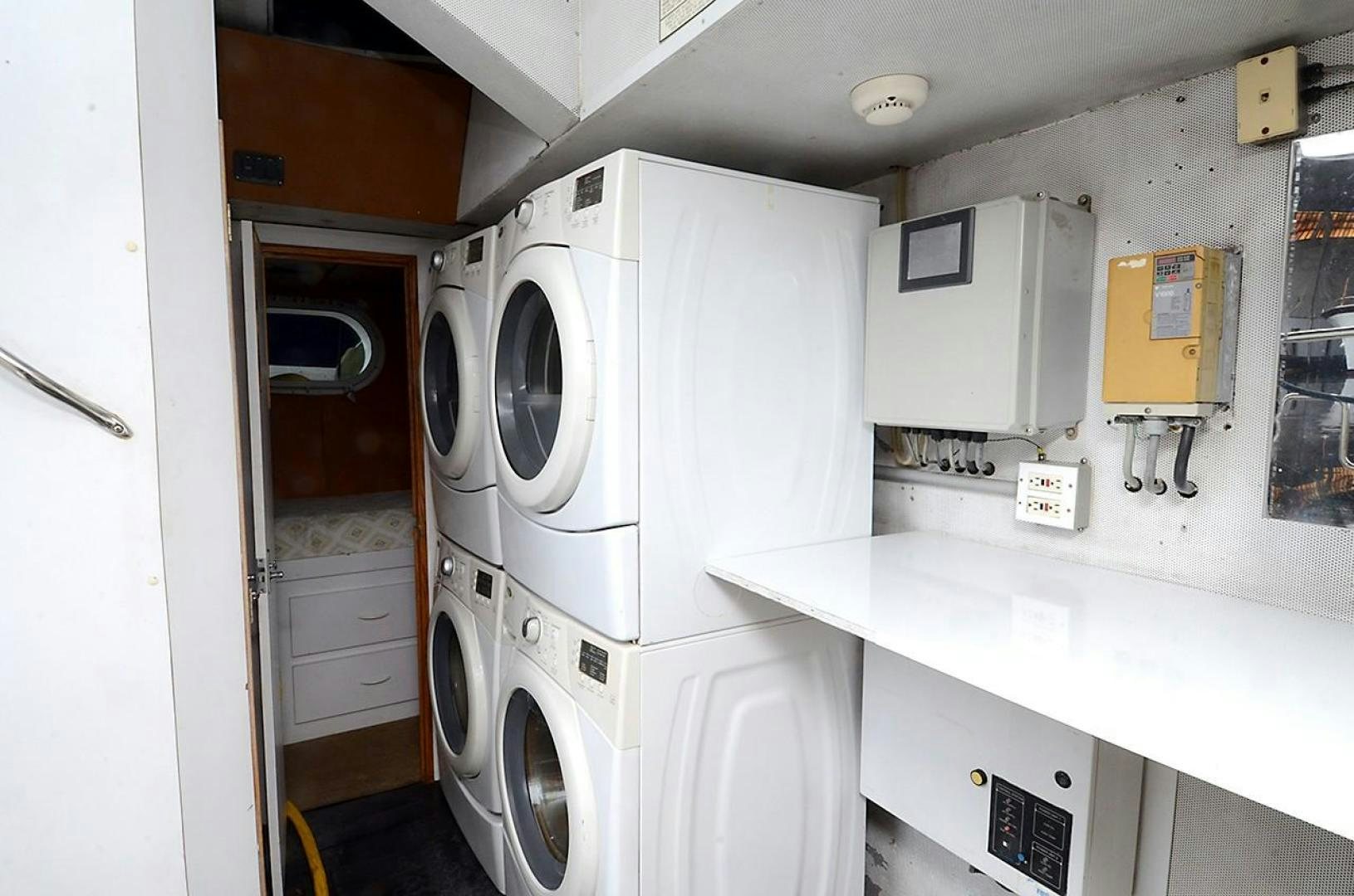a room with a washing machine and cabinets aboard OUTTA TOUCH Yacht for Sale