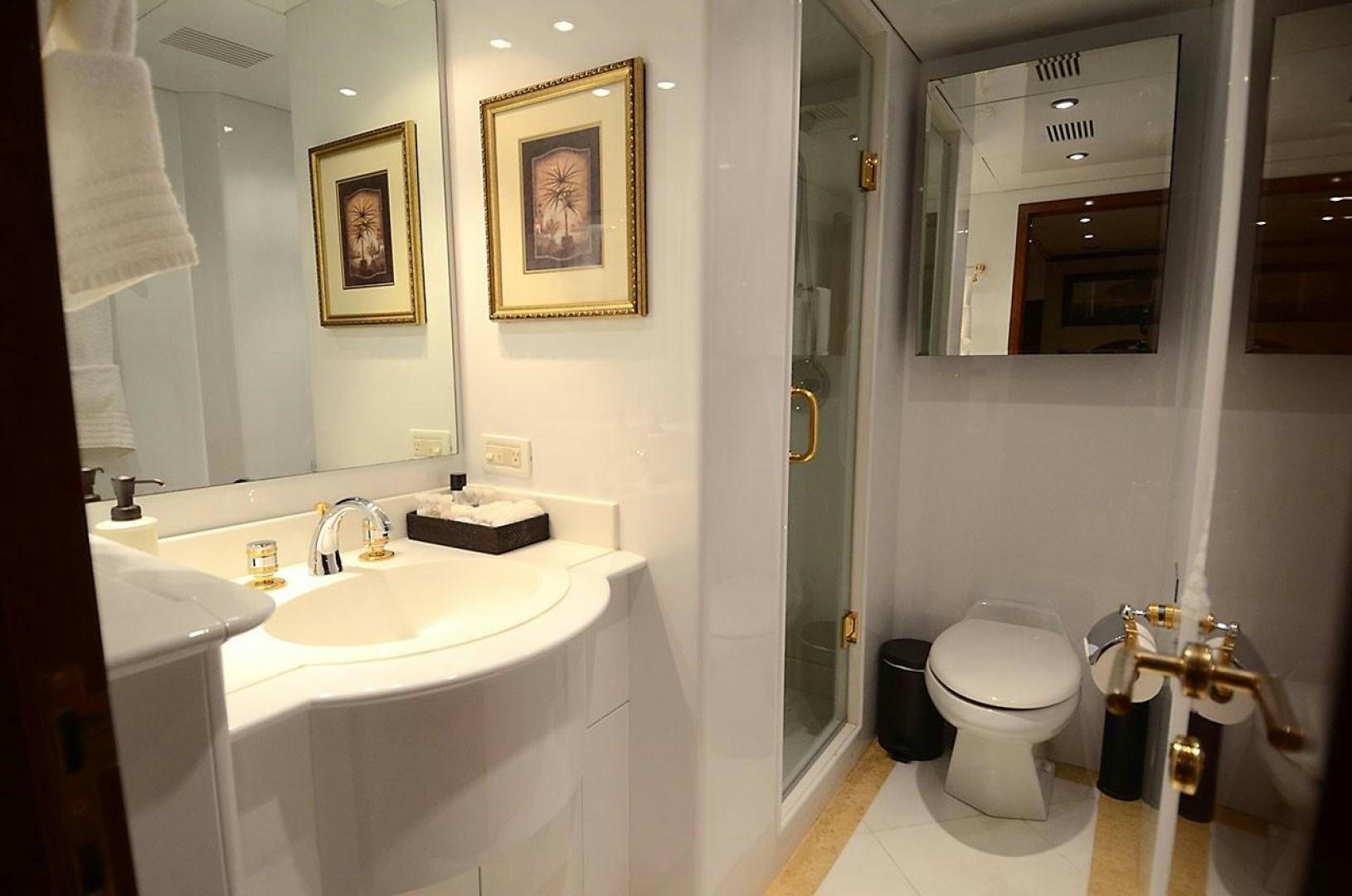 a bathroom with a sink toilet and a mirror aboard OUTTA TOUCH Yacht for Sale
