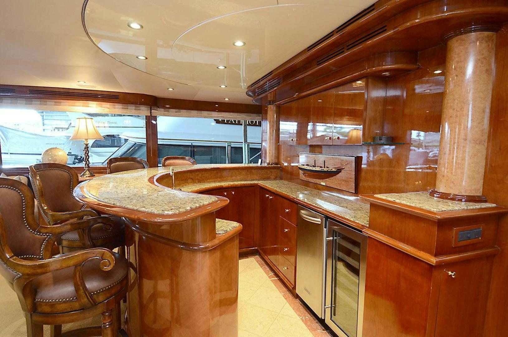 a kitchen with a bar and a table aboard OUTTA TOUCH Yacht for Sale
