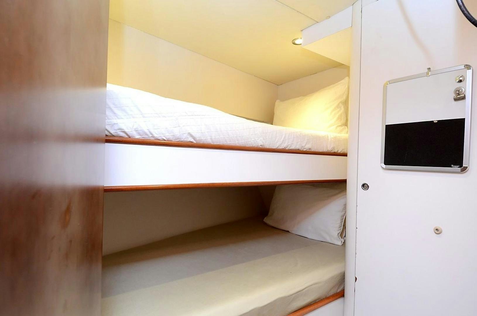 a bed with a laptop on it aboard OUTTA TOUCH Yacht for Sale