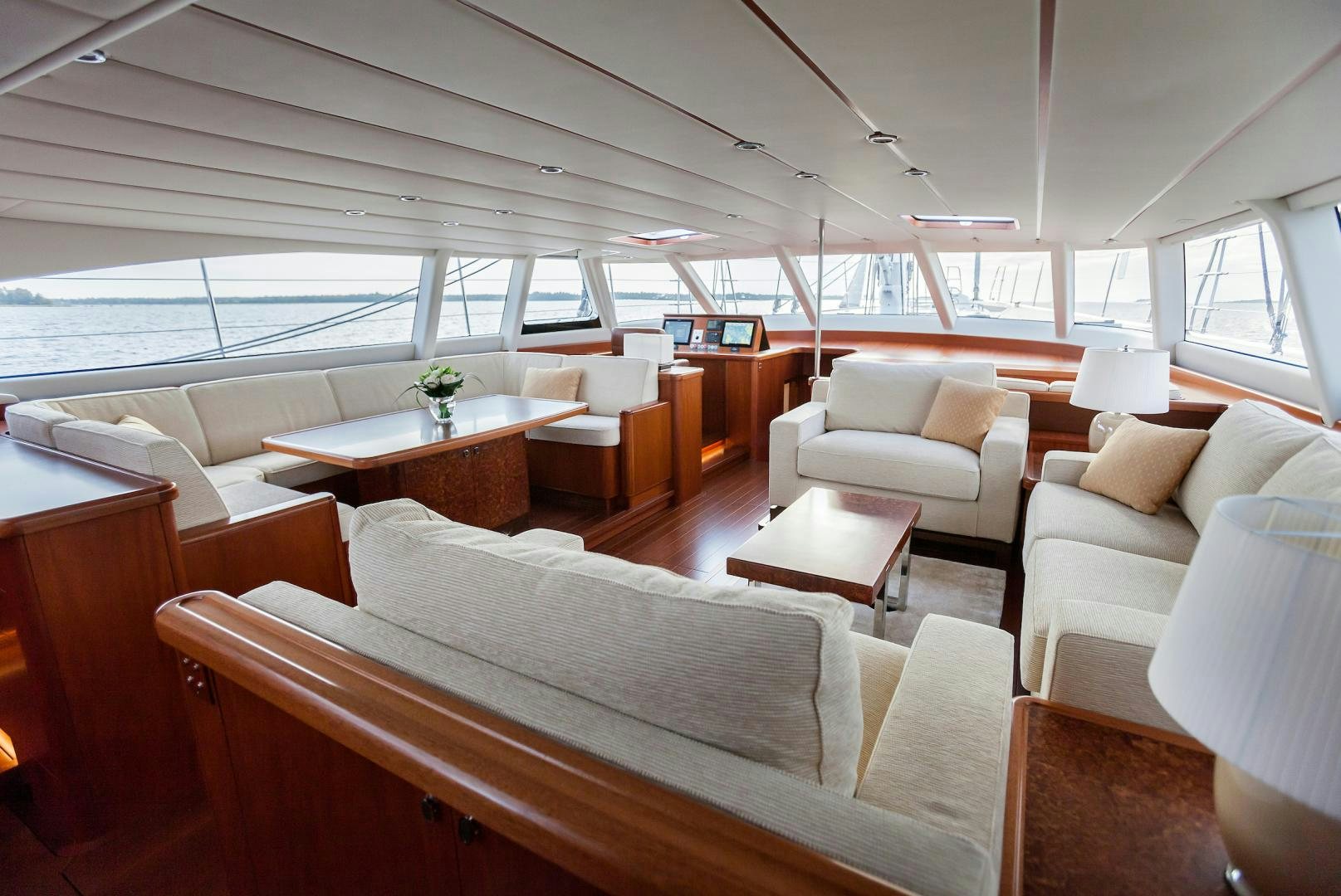 a room with a couch and a table and a window aboard CHILD OF LIR  Yacht for Sale