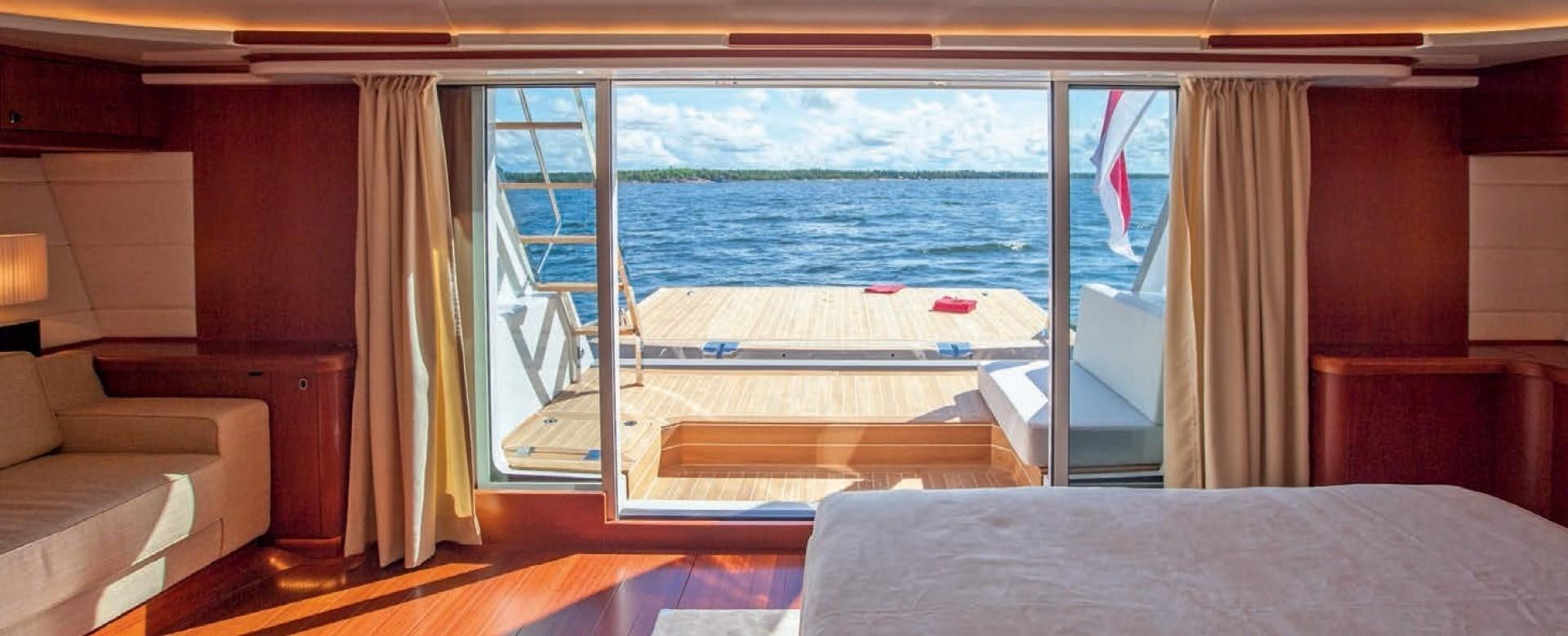 a room with a bed and a window aboard CHILD OF LIR  Yacht for Sale