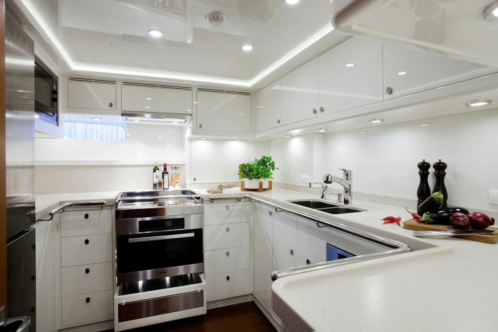a kitchen with white cabinets aboard CHILD OF LIR  Yacht for Sale