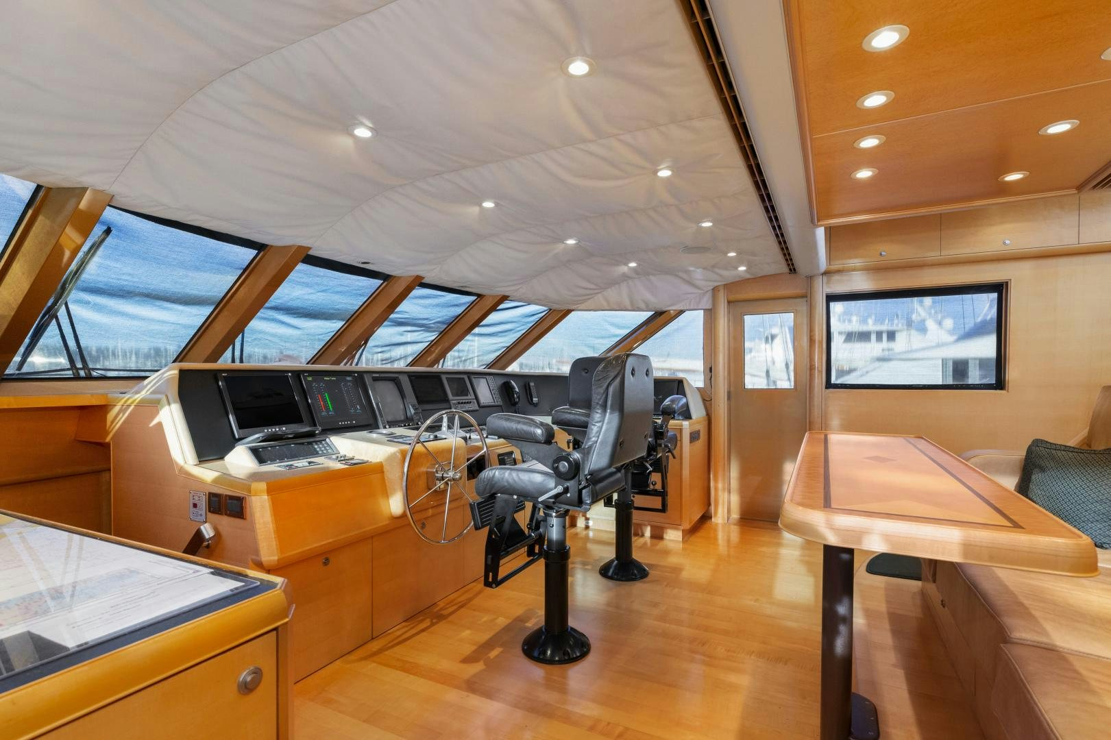 a room with a table and chairs aboard ILLEAGLE Yacht for Sale