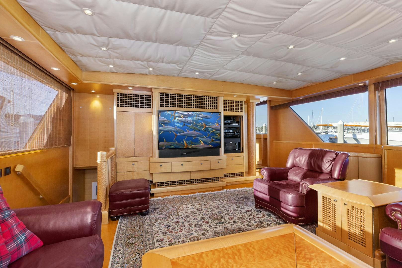 a living room with a large screen aboard ILLEAGLE Yacht for Sale