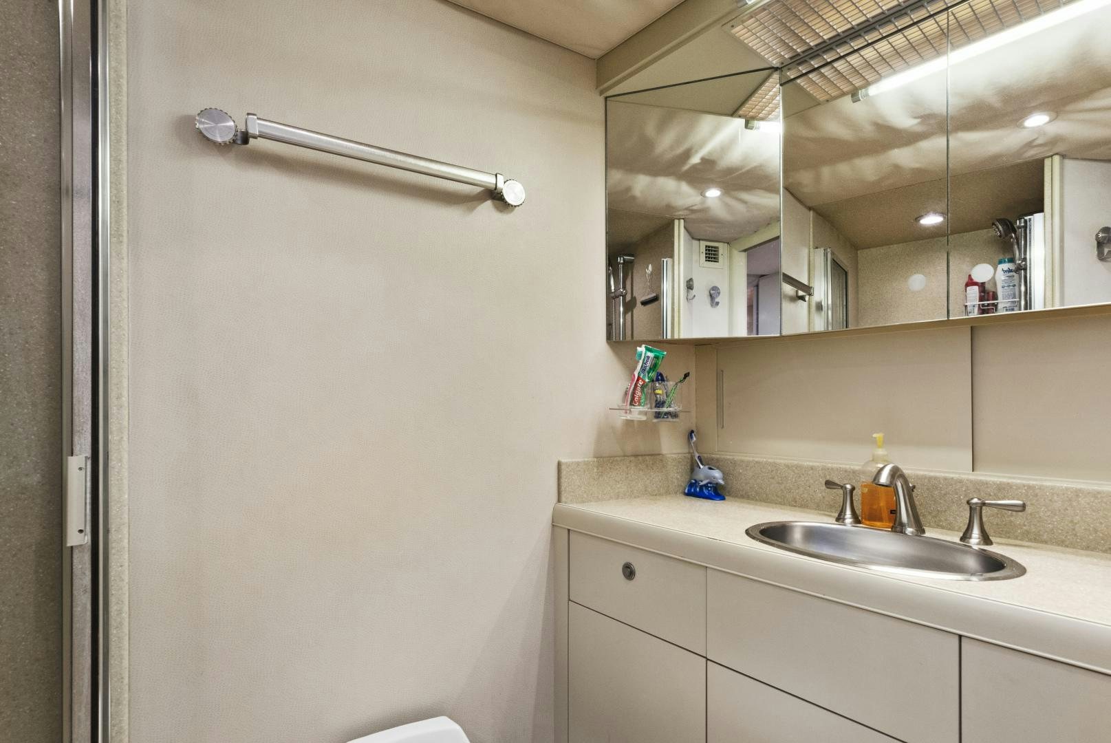 a bathroom with a sink and a mirror aboard ILLEAGLE Yacht for Sale