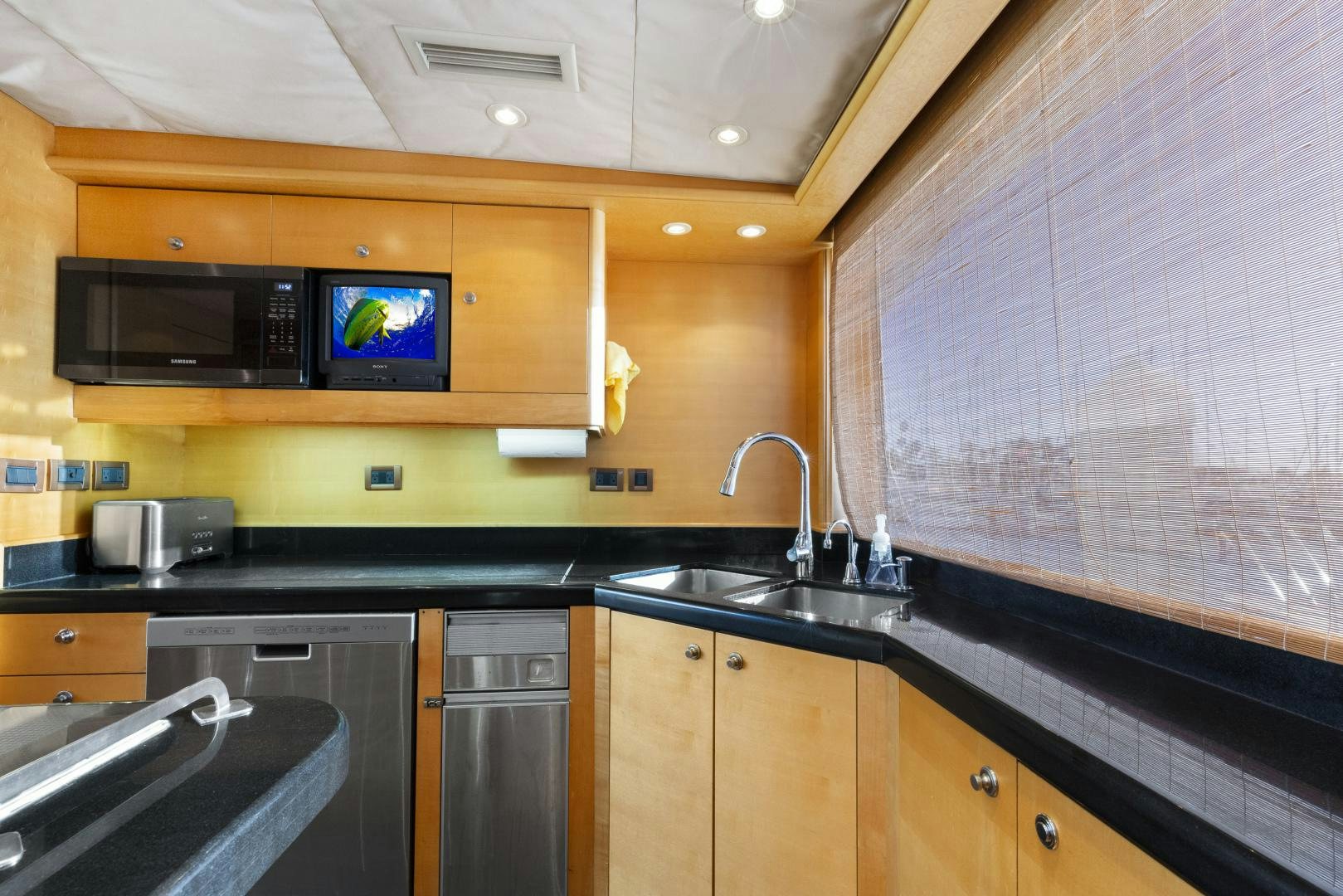 a kitchen with a tv and a microwave aboard ILLEAGLE Yacht for Sale