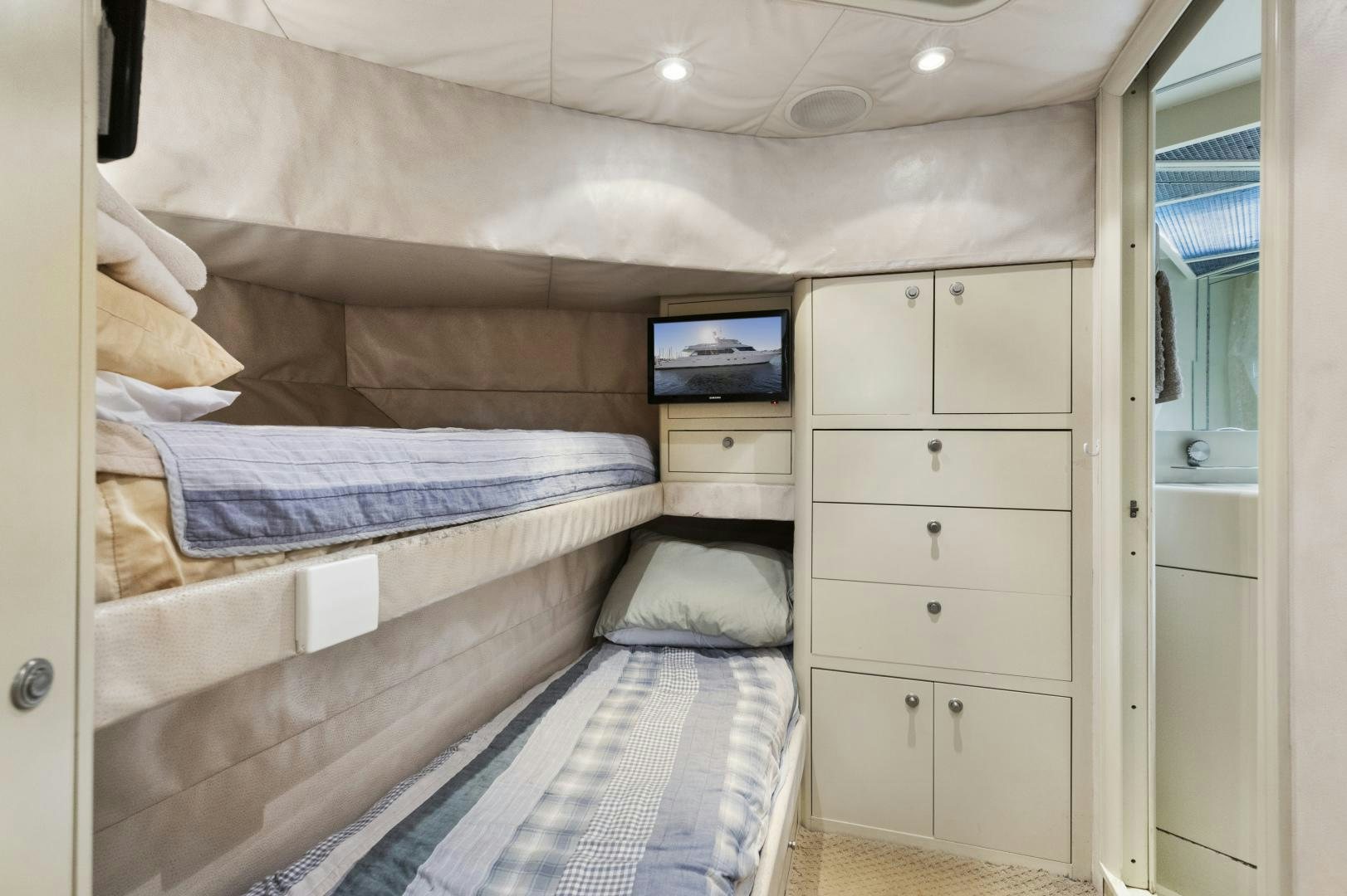 a bedroom with a bed and a dresser aboard ILLEAGLE Yacht for Sale