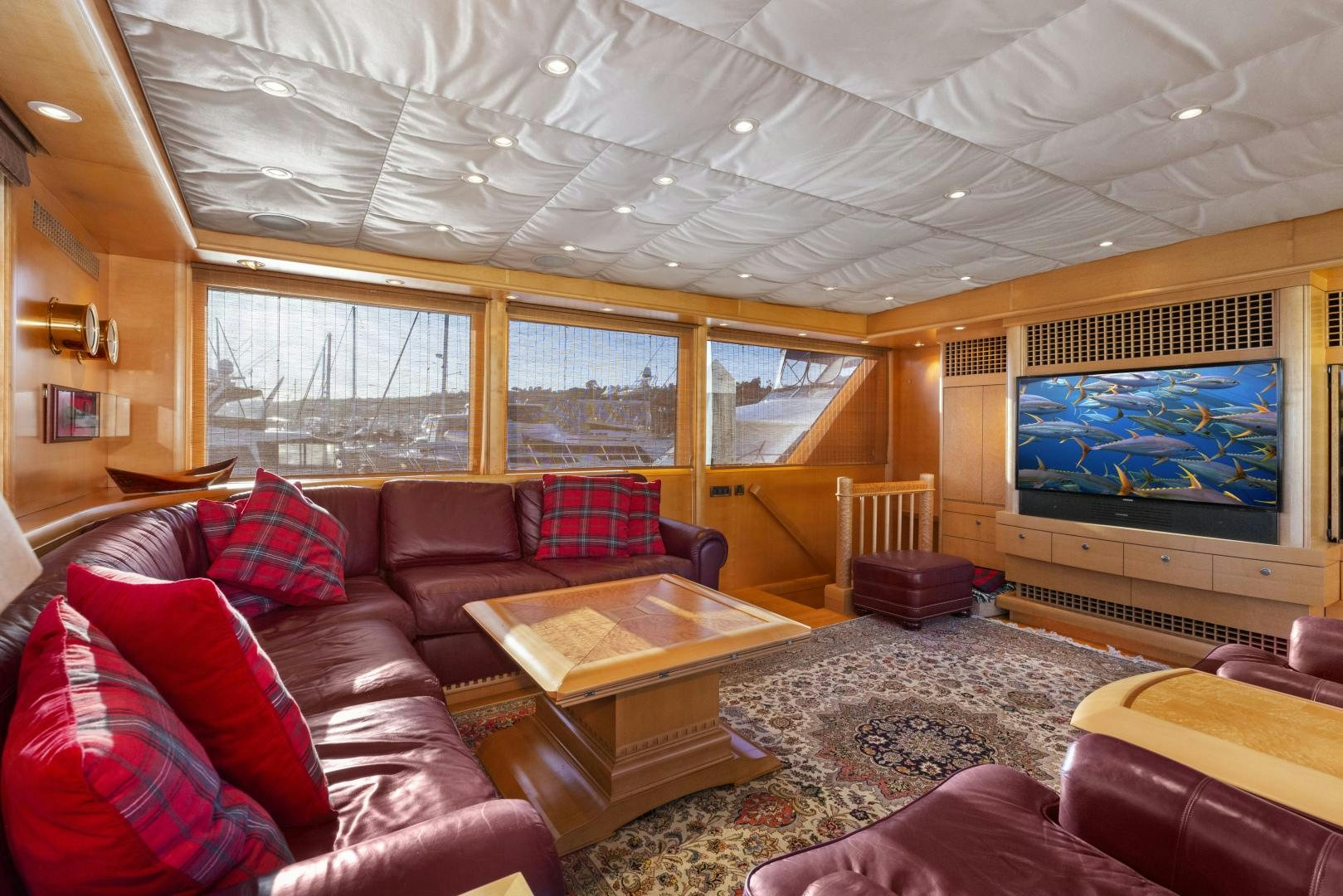 a living room with a large screen aboard ILLEAGLE Yacht for Sale