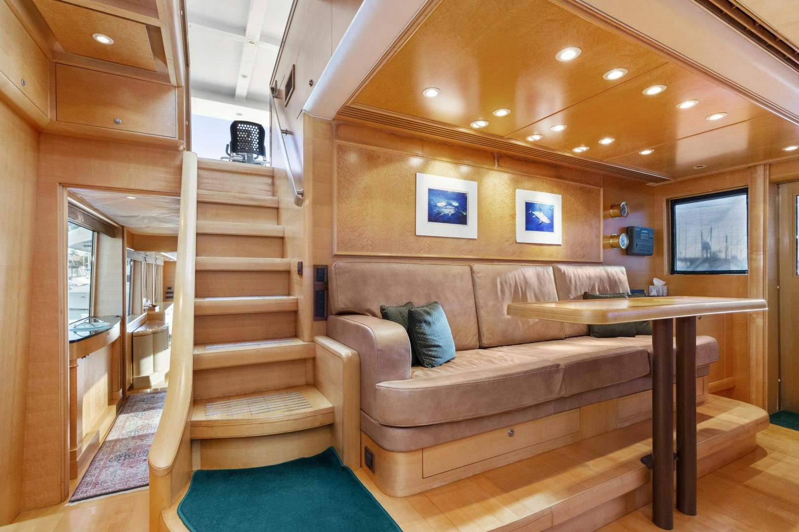a living room with a wood staircase aboard ILLEAGLE Yacht for Sale