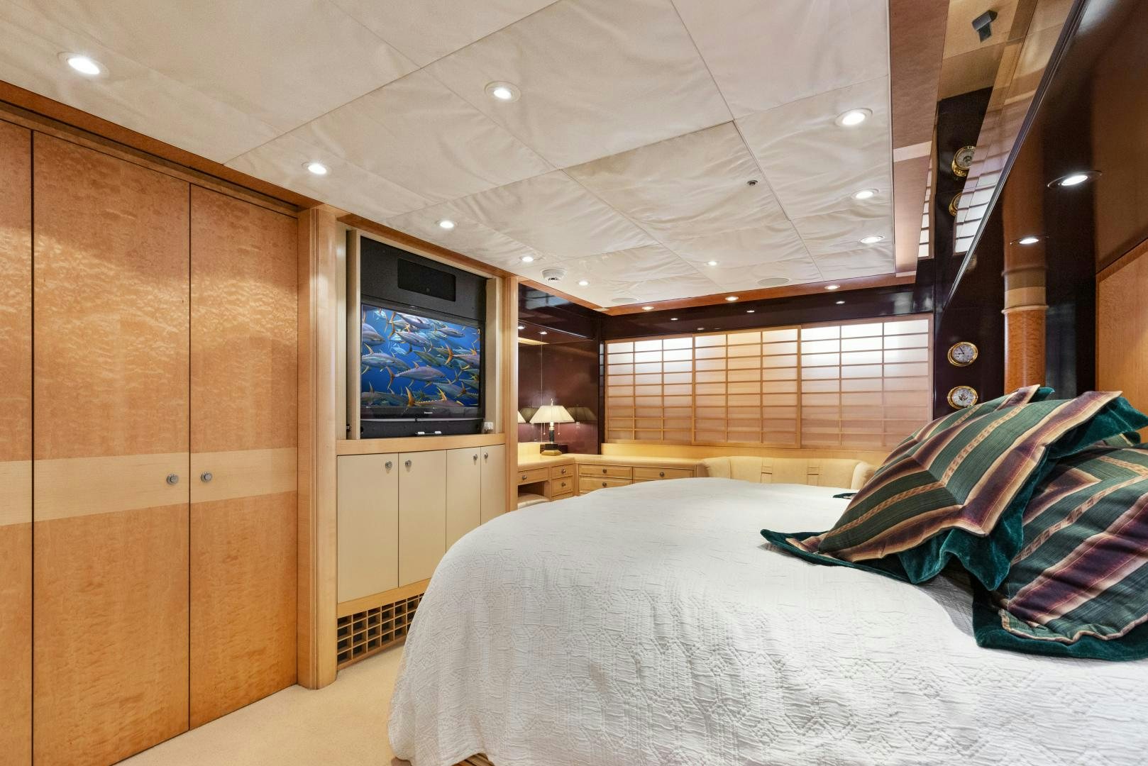 a bedroom with a bed and a tv aboard ILLEAGLE Yacht for Sale