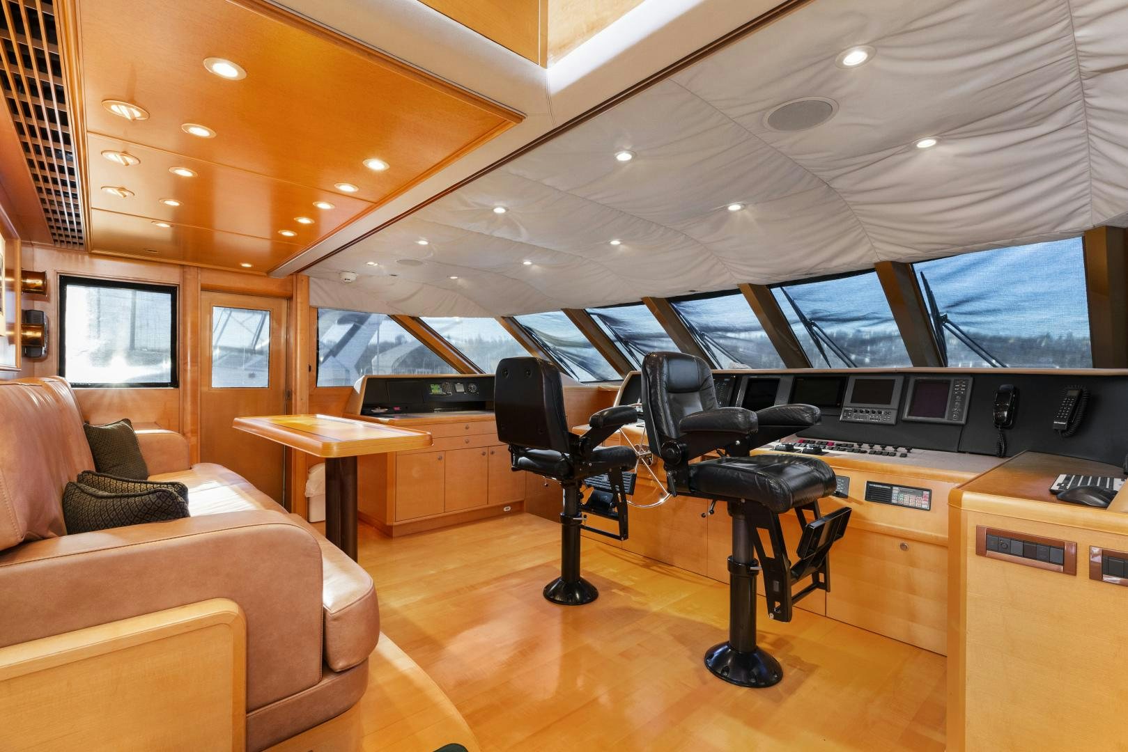 a room with a desk and a chair and a couch aboard ILLEAGLE Yacht for Sale