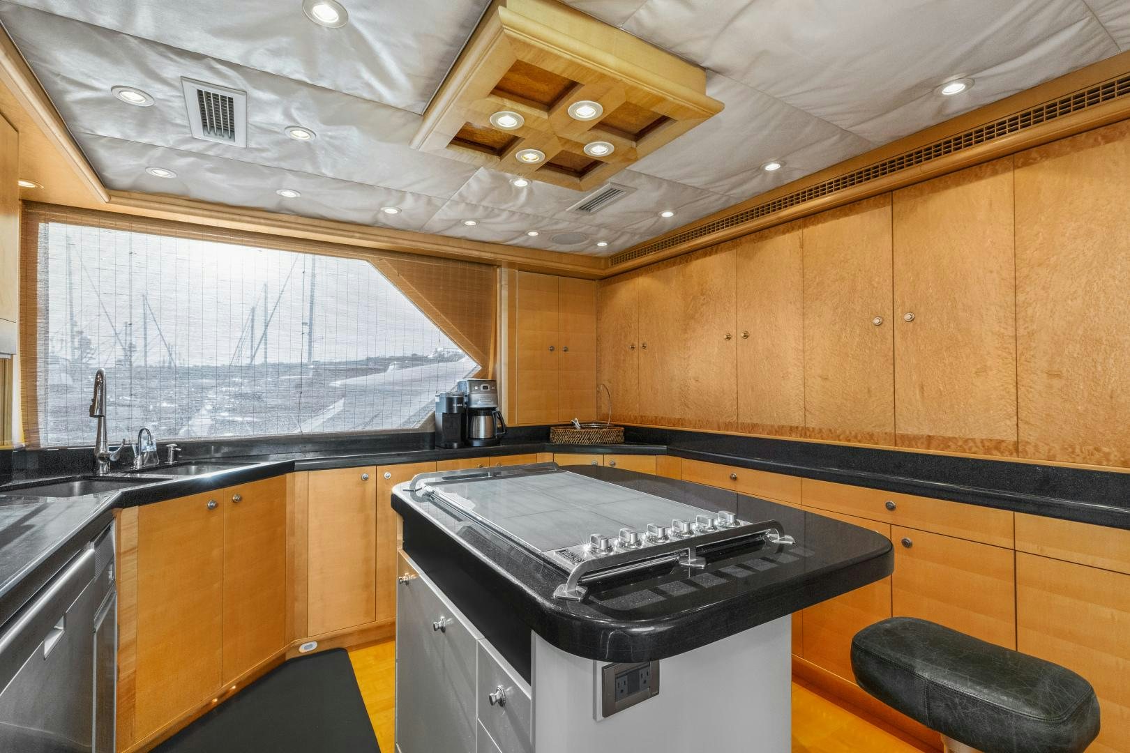 a kitchen with wooden cabinets aboard ILLEAGLE Yacht for Sale