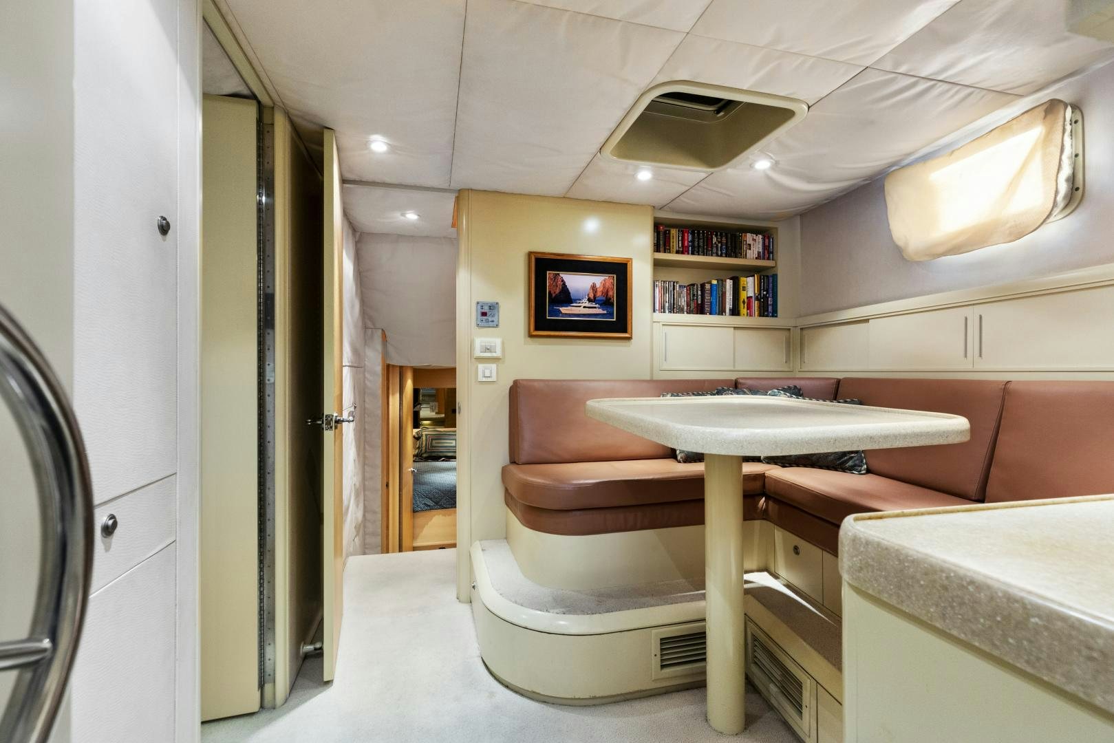 a room with a table and a couch aboard ILLEAGLE Yacht for Sale