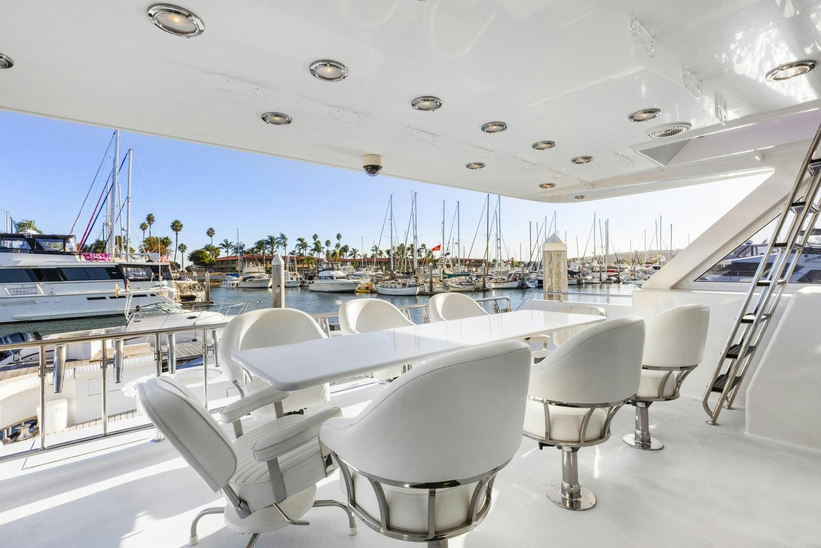 a white table with chairs on it aboard ILLEAGLE Yacht for Sale