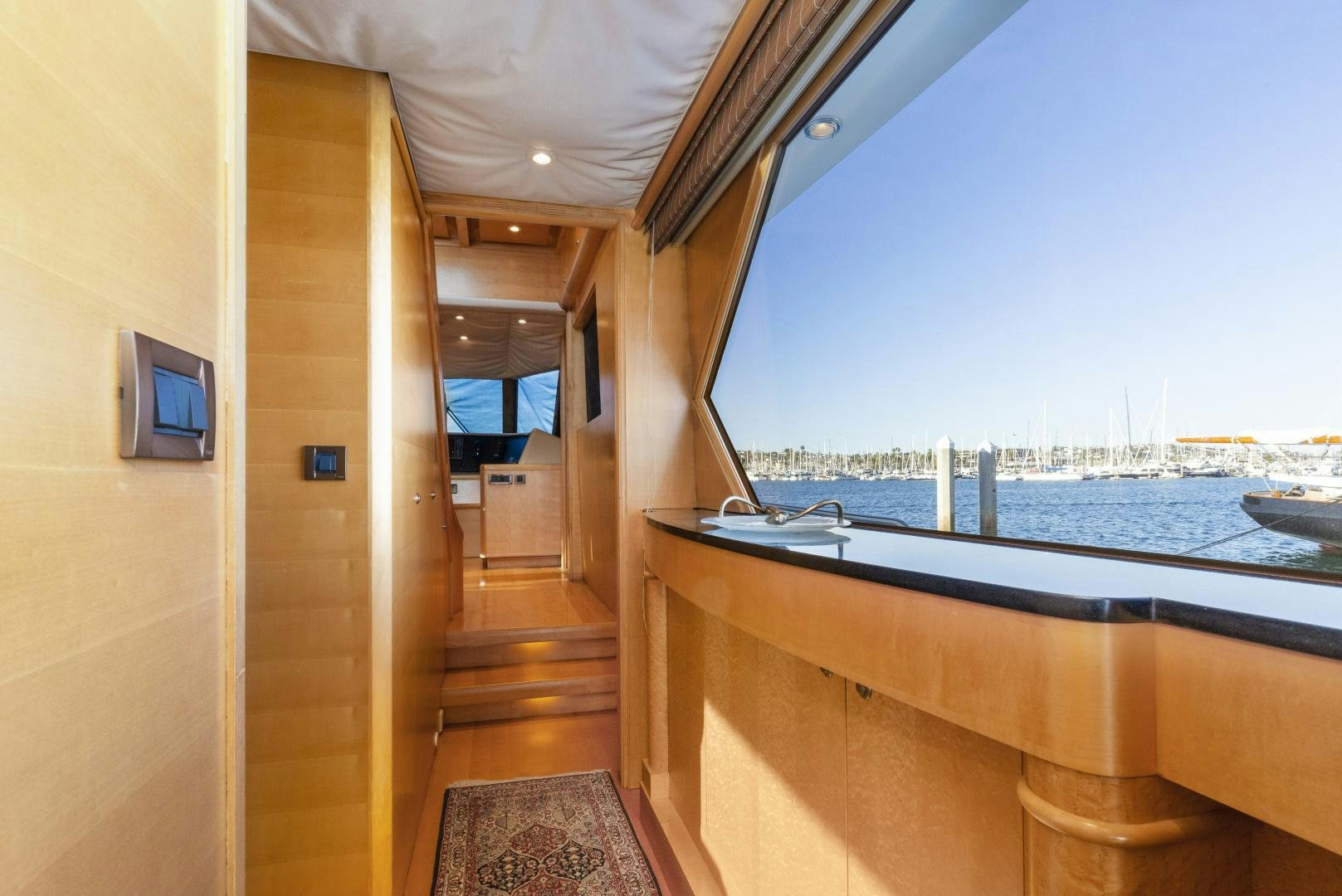 a wooden walkway leading to a beach aboard ILLEAGLE Yacht for Sale