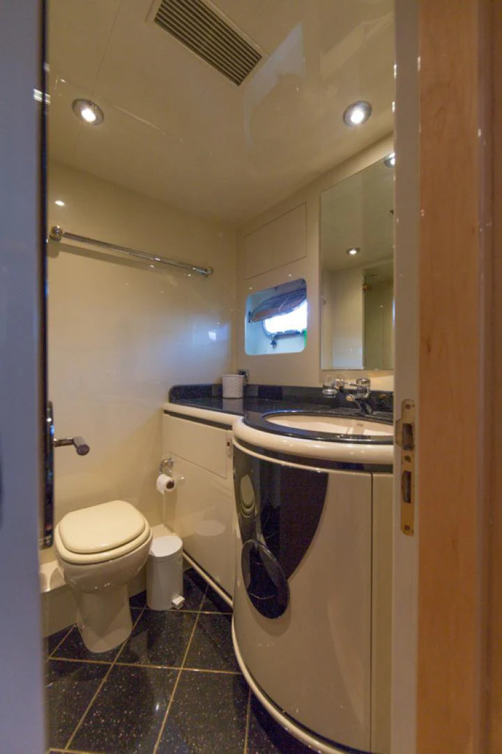 a bathroom with a sink toilet and a mirror aboard MR. CAT Yacht for Sale