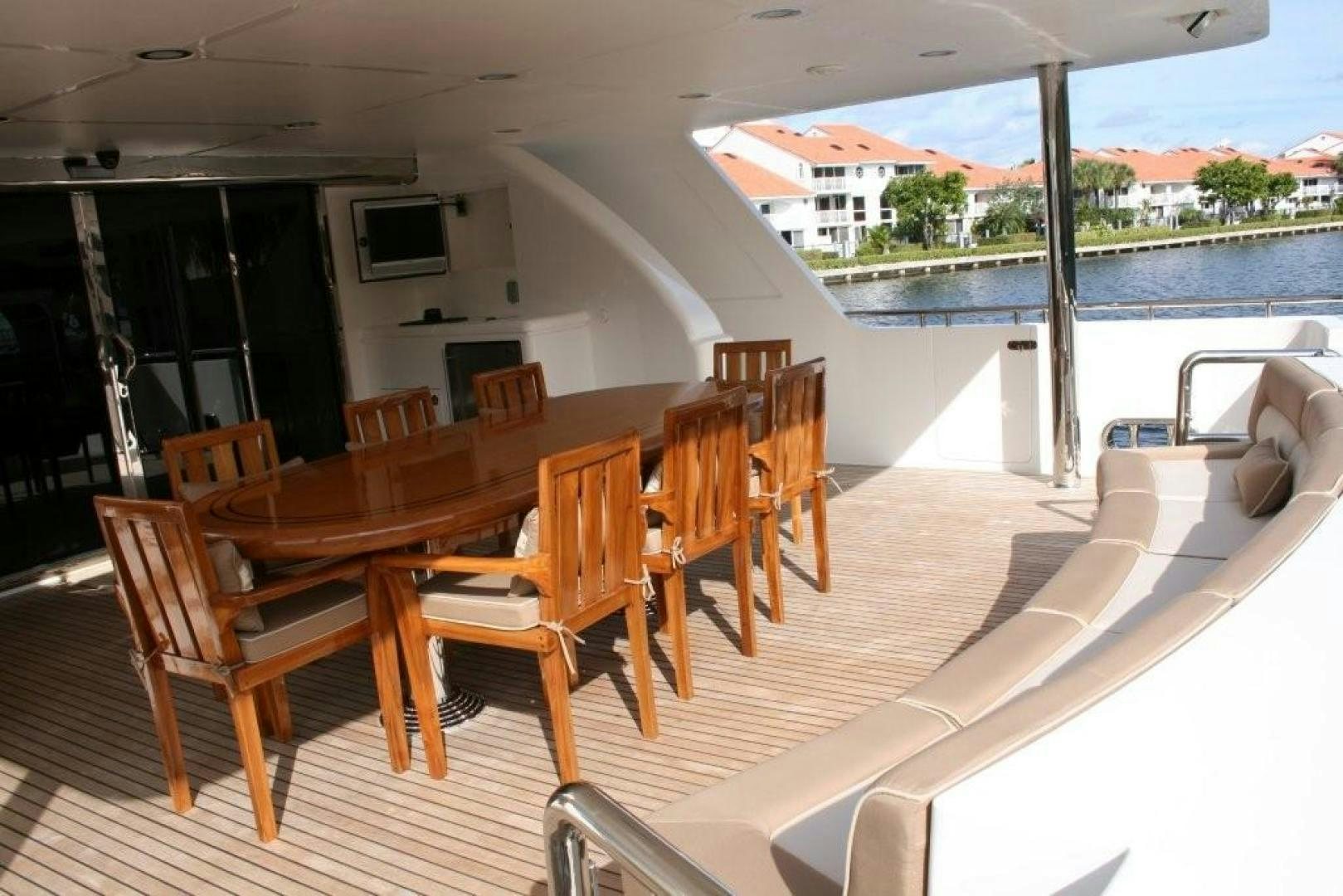 a deck with chairs and a television on it aboard D FENCE Yacht for Sale