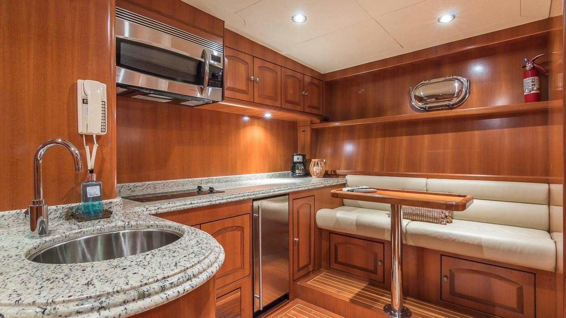 a kitchen with wooden cabinets aboard D FENCE Yacht for Sale