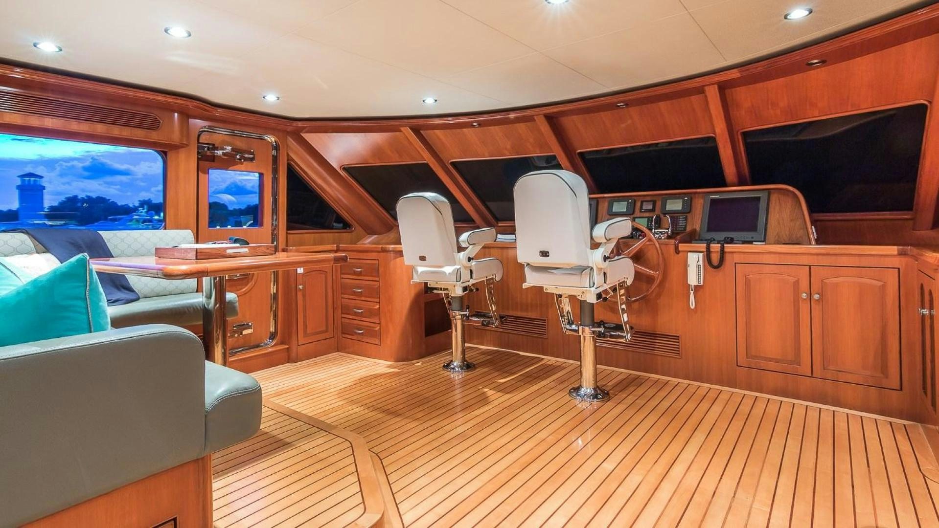 a room with a chair and a desk with a tv on it aboard D FENCE Yacht for Sale
