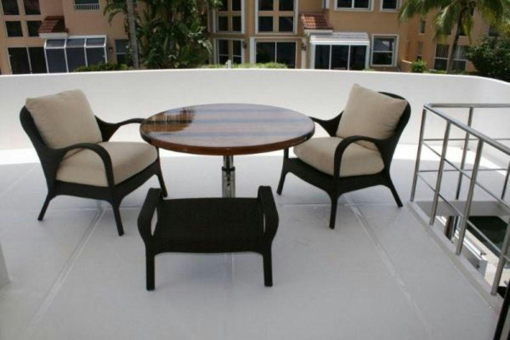 a table and chairs on a patio aboard D FENCE Yacht for Sale