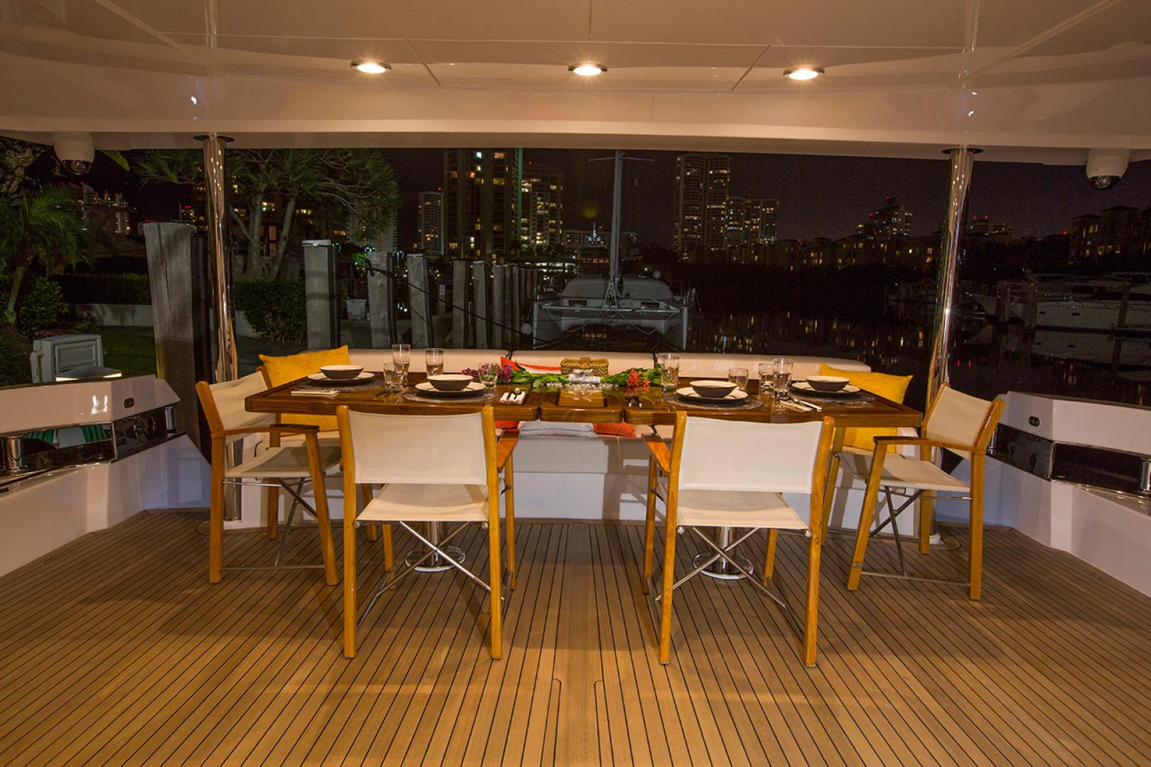 a large room with tables and chairs aboard 2021 HATTERAS 105RPH Yacht for Sale